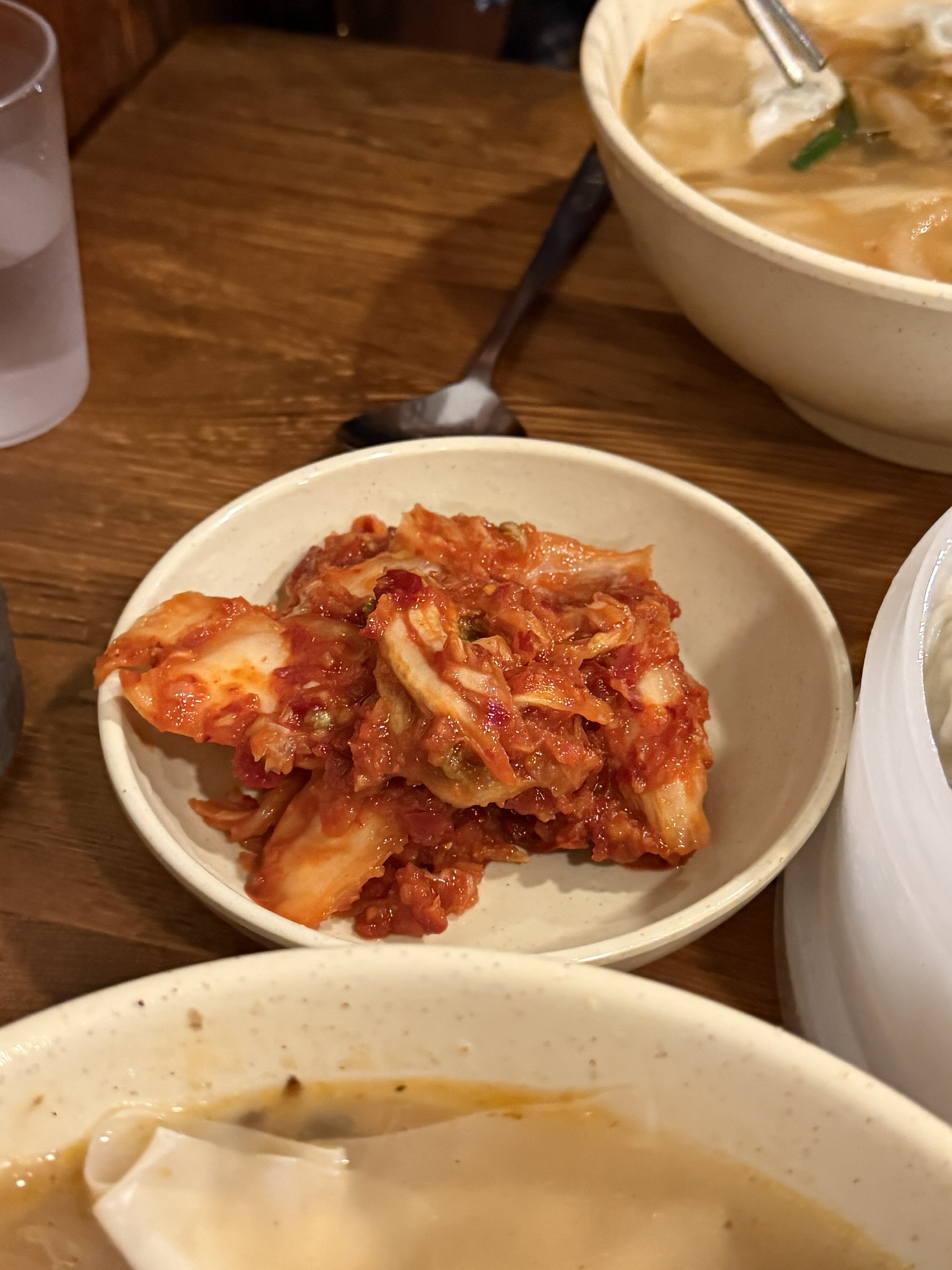 Small dish of garlic kimchi served at Myeongdong Kyoja, bright red and freshly mixed