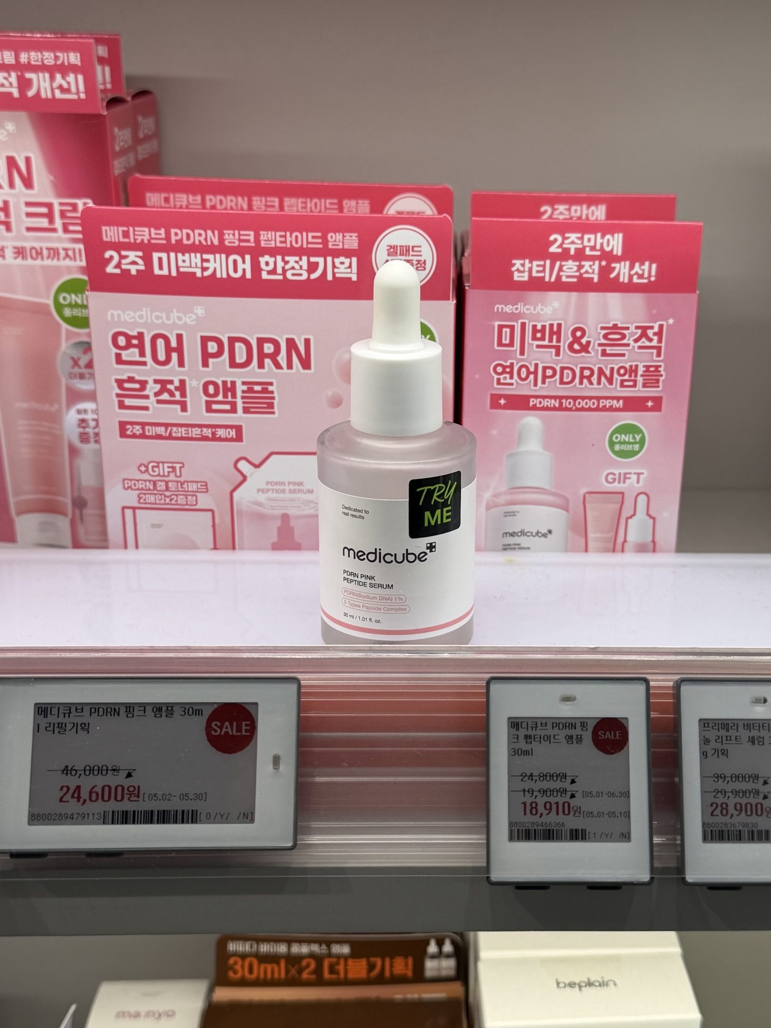 Medicube PDRN Pink Peptide Serum on display at an Olive Young store in Korea with sale price tags showing 18,910 won