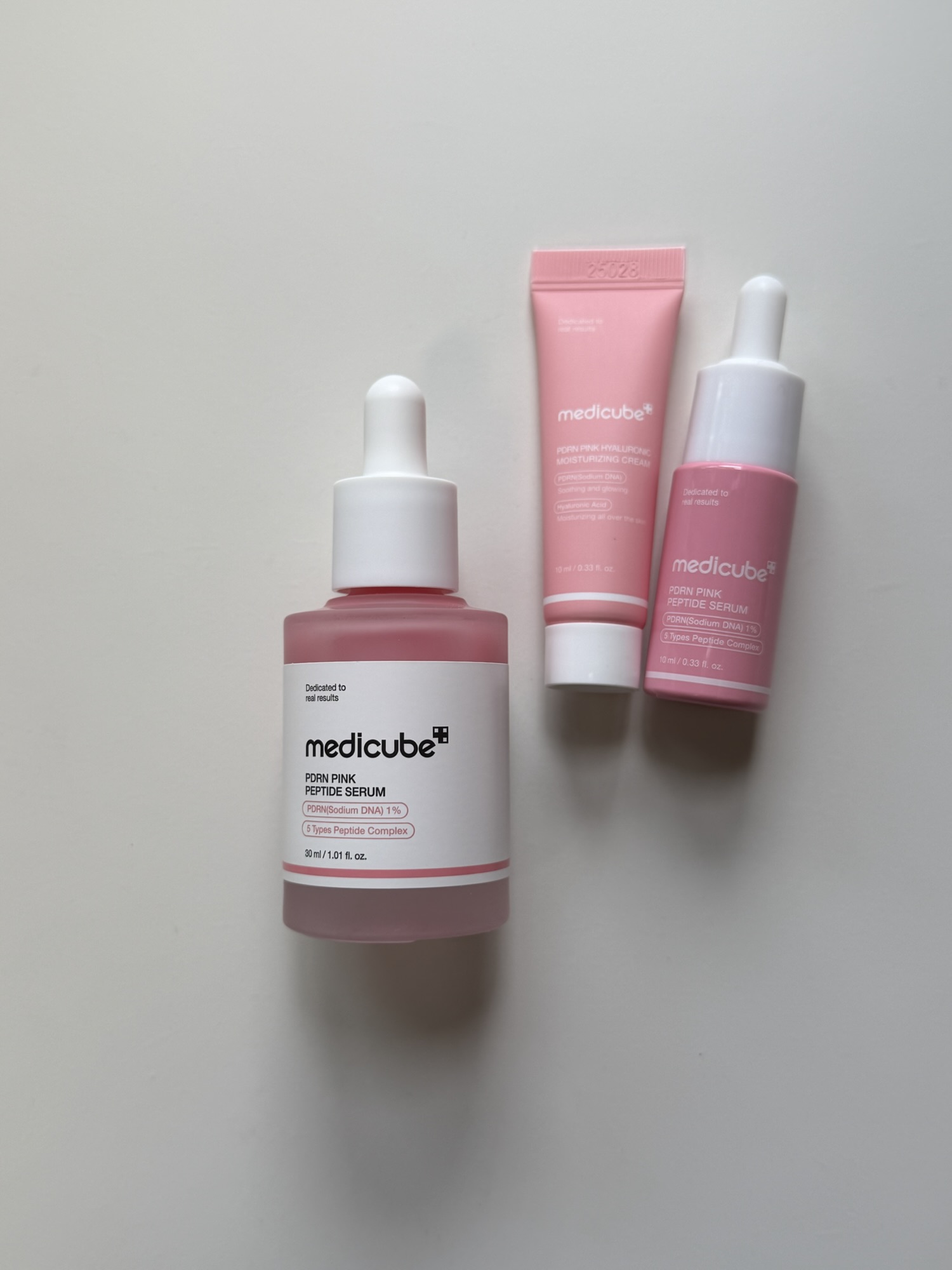 Medicube PDRN Pink Peptide Serum 30ml dropper bottle with the Olive Young gift set mini ampoule and mini moisturizing cream — travel-friendly bonus minis