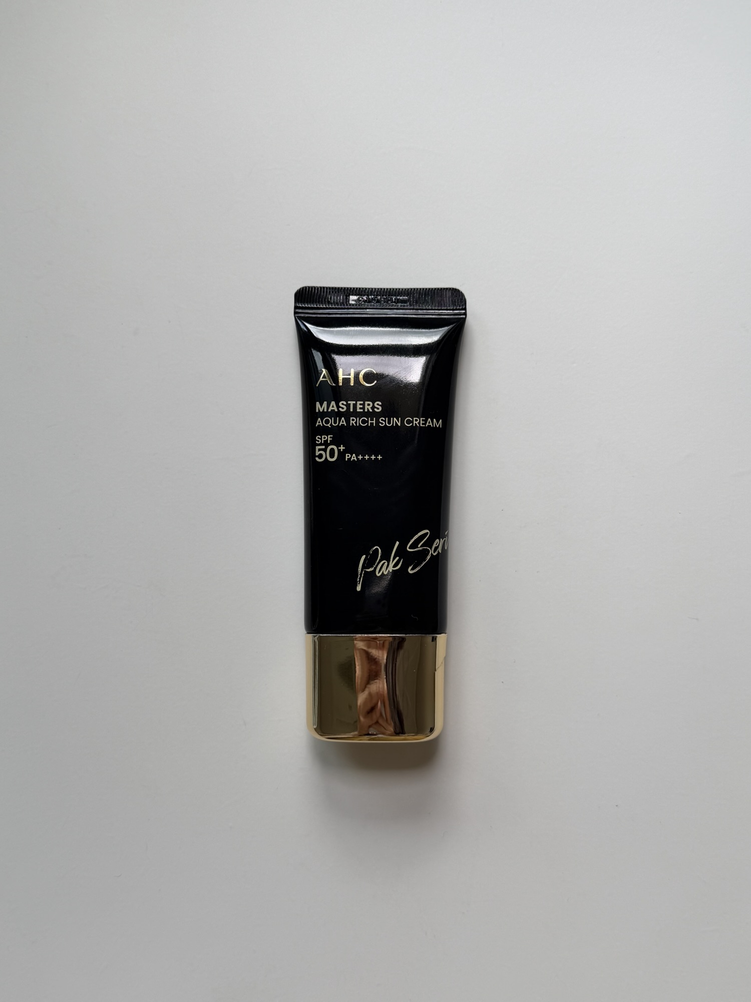 AHC Masters Aqua Rich Sun Cream — SPF50+ PA++++ black tube with gold cap