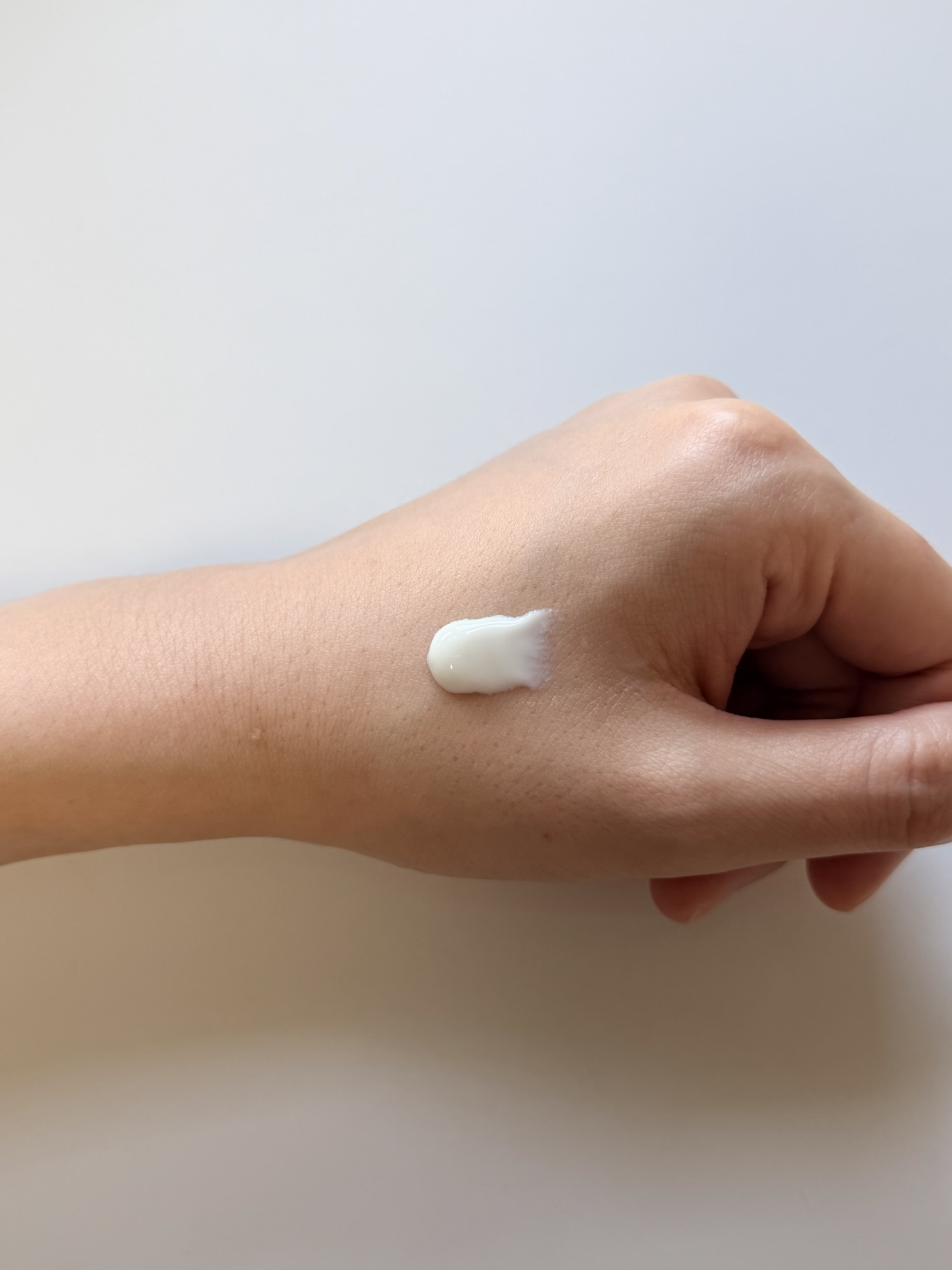 ROUND LAB Birch Juice sunscreen texture on hand — white lotion-like consistency before spreading