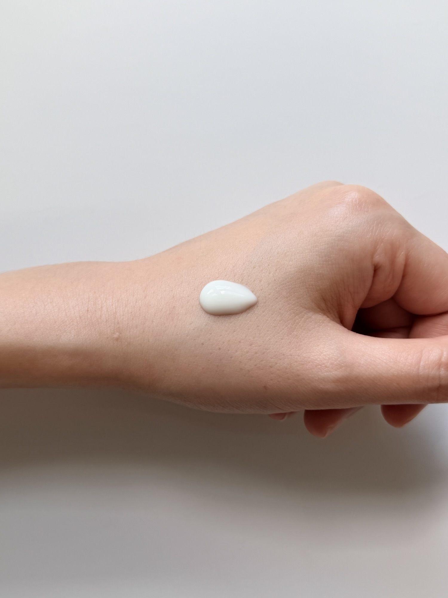 COSRX Invisible Sunscreen texture on hand — serum-like watery consistency before spreading