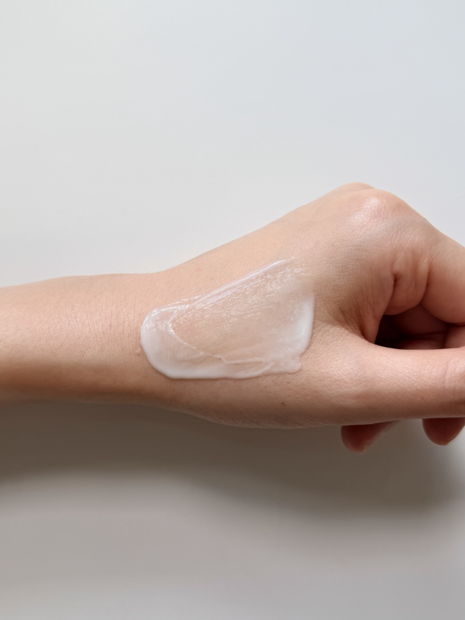 COSRX Invisible Sunscreen blended on hand — transparent absorption, no stickiness