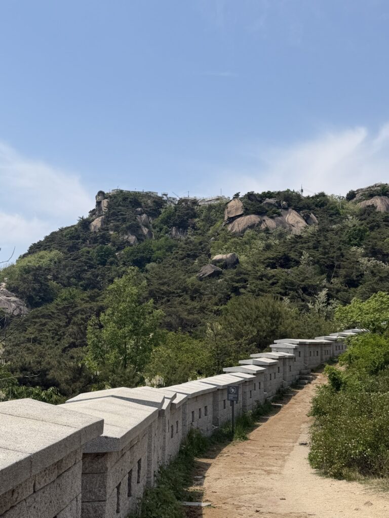 Seoul Fortress Wall stone path on Inwangsan with rocky granite peaks in background