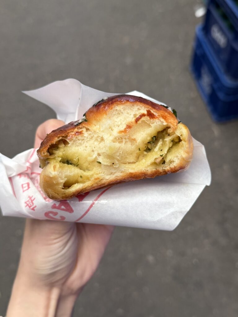 Garlic Boy bread torn open showing the soft buttery garlic filling inside