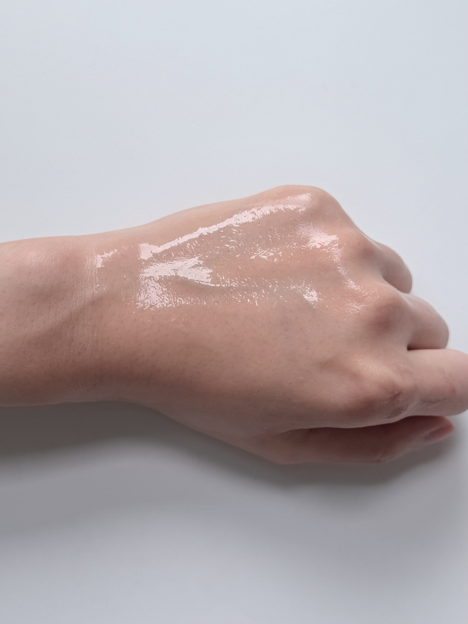 Patting essence into skin after lifting Rejuran toner pad — absorbs cleanly with no sticky film