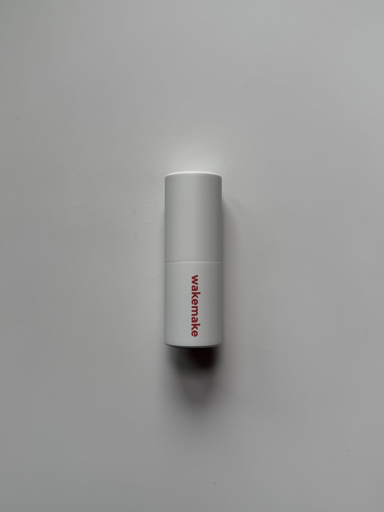 Wakemake Blurring Balm Stick white matte tube with magnetic cap — compact, thumb-sized