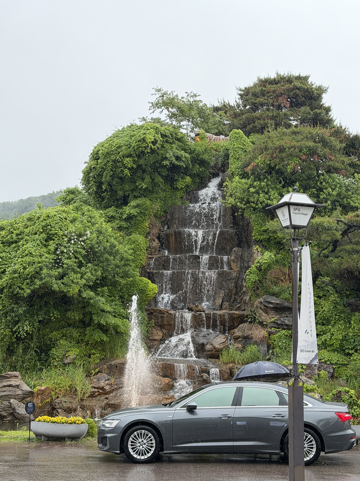 Entrance to Songdo Galbi (송도갈비) featuring a large artificial waterfall and garden — unexpectedly grand for a galbi restaurant