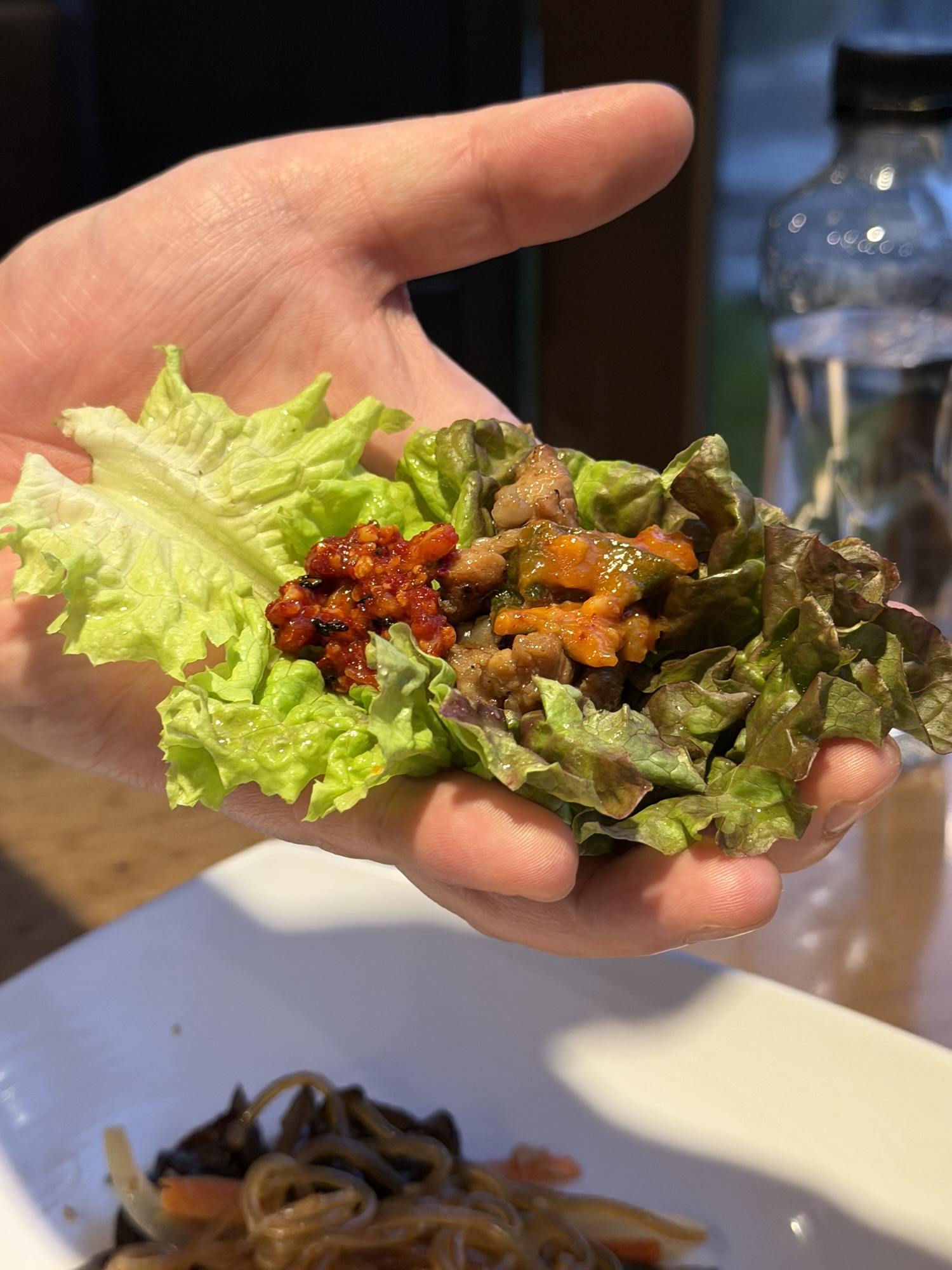 A ssam wrap loaded with galbi, gochujang, and spicy dried radish strips (무말랭이) at Songdo Galbi