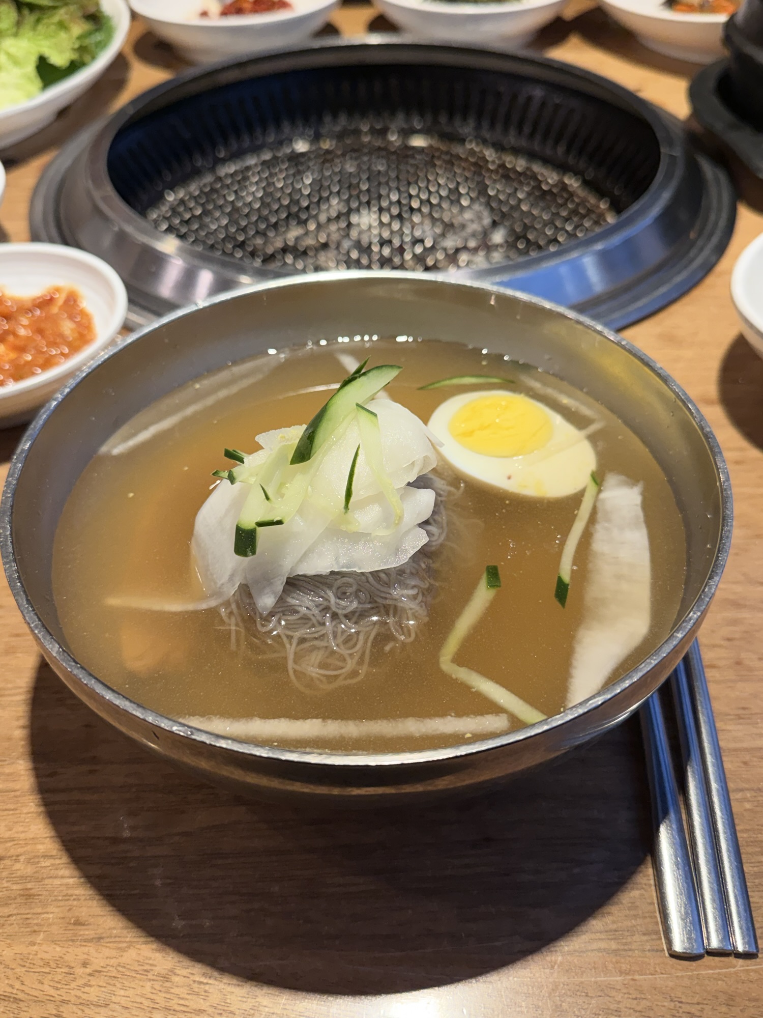 Mul-naengmyeon (물냉면) at Songdo Galbi — chilled buckwheat noodles in clear broth with sliced Korean radish, cucumber, and half a boiled egg