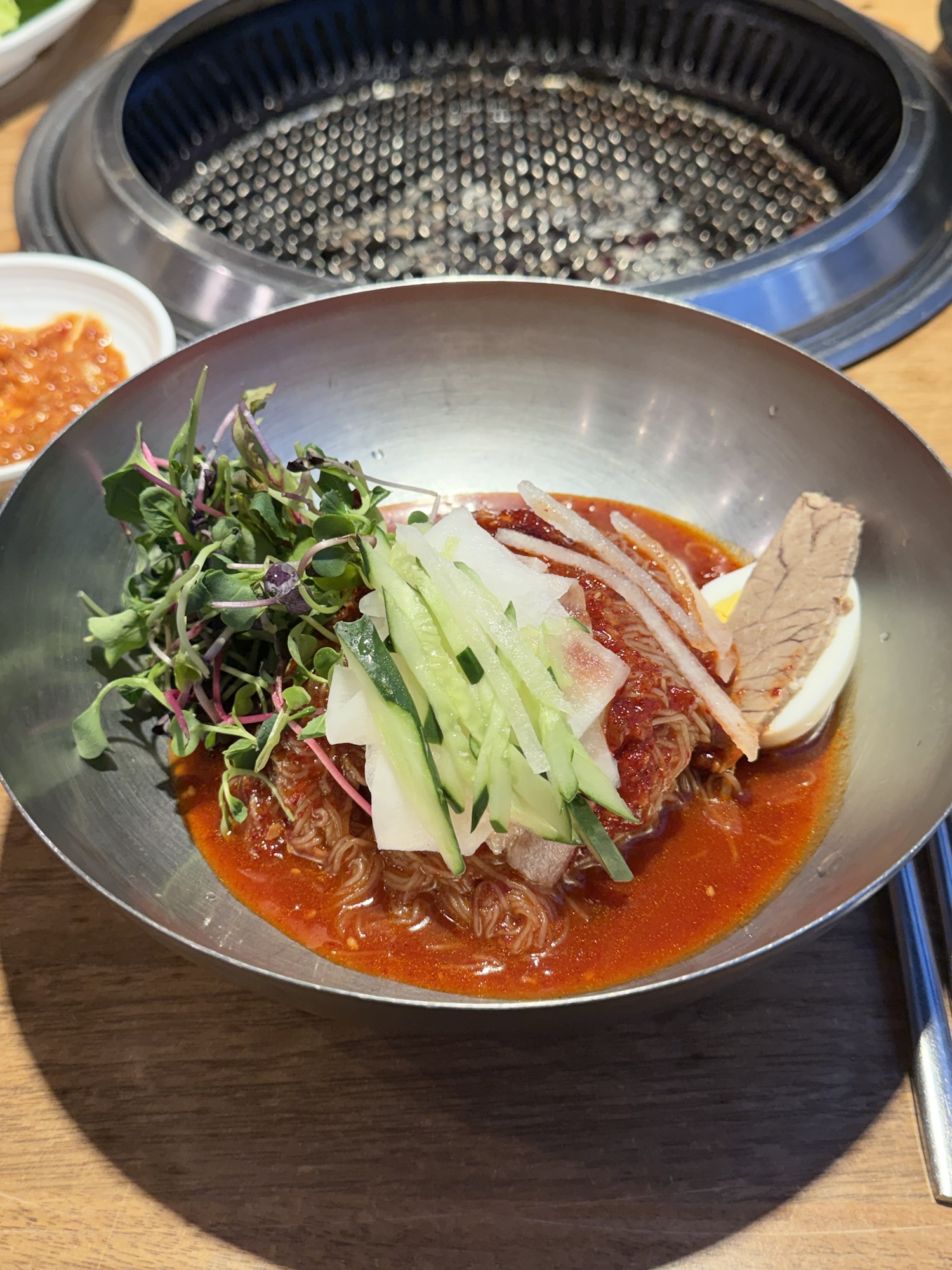 Bibim-naengmyeon (비빔냉면) at Songdo Galbi — buckwheat noodles coated in spicy red sauce, topped with cucumber, radish, and boiled pork