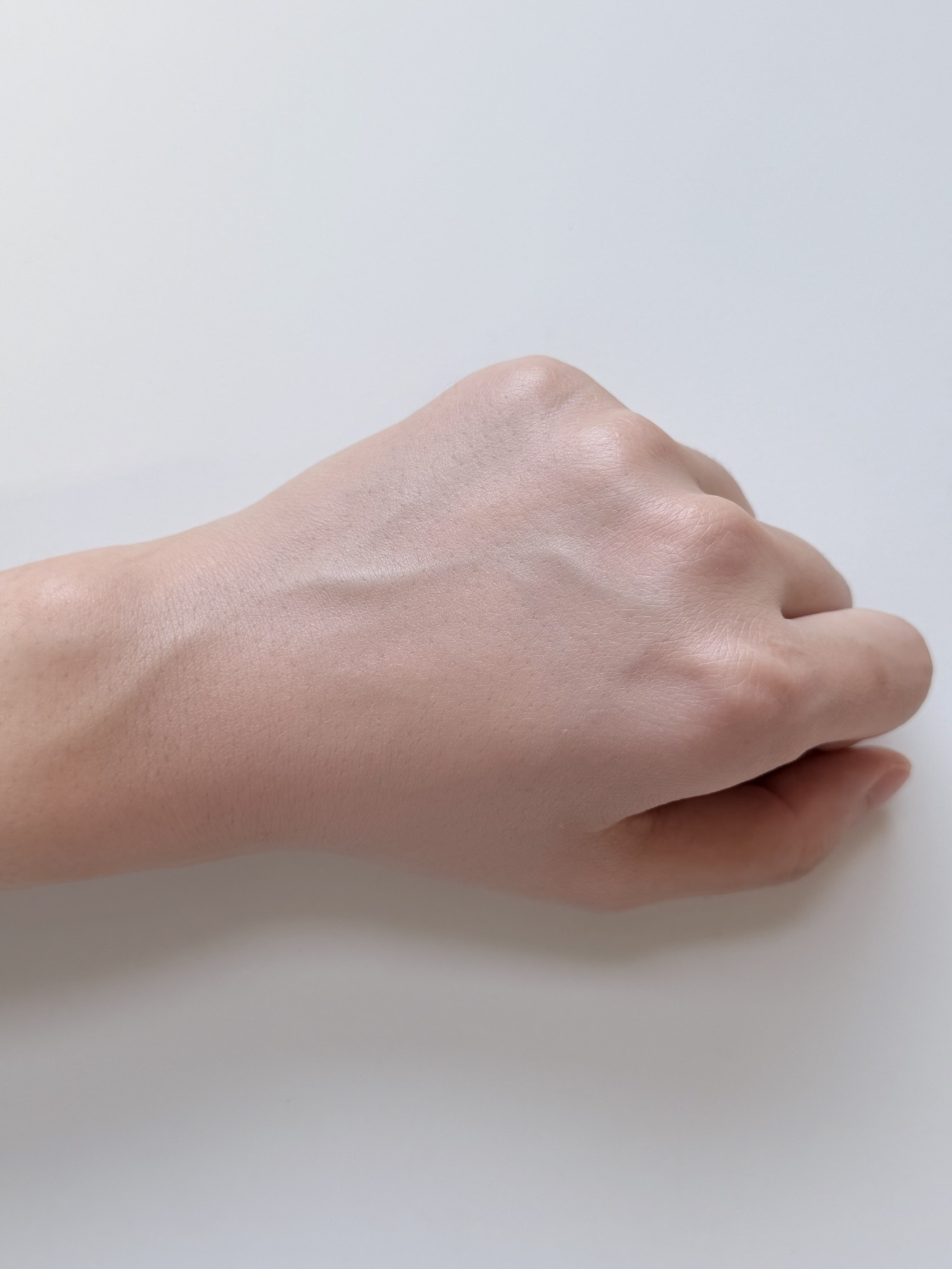 Finished Chasing Rabbit Glow Cover Cream hand swatch after blending with the puff showing natural tone-up coverage