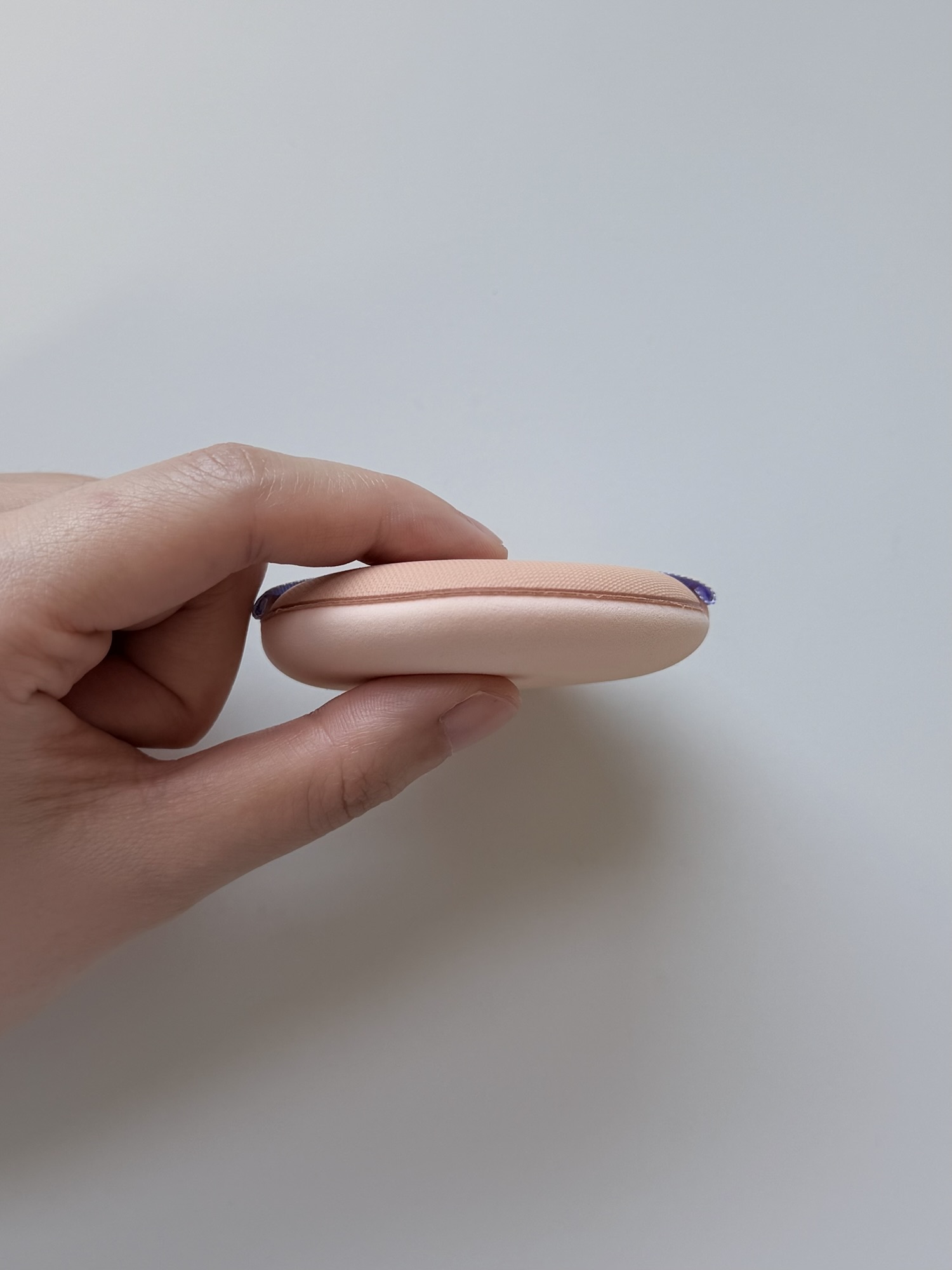Side view of the thick Chasing Rabbit makeup puff included with the cover cream