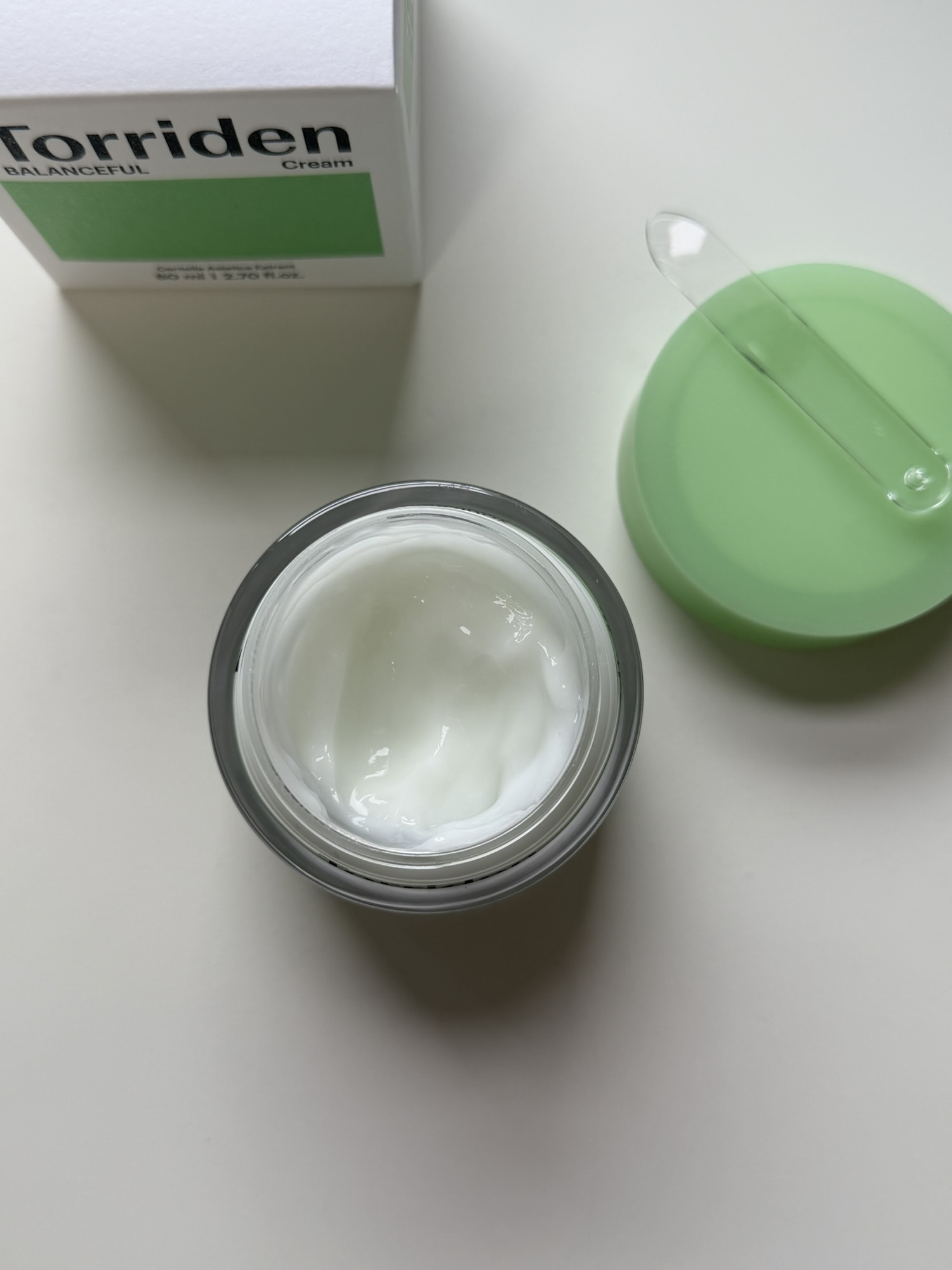 Torriden Balanceful Cica Cream jar close-up with the lid off showing the pale cream surface