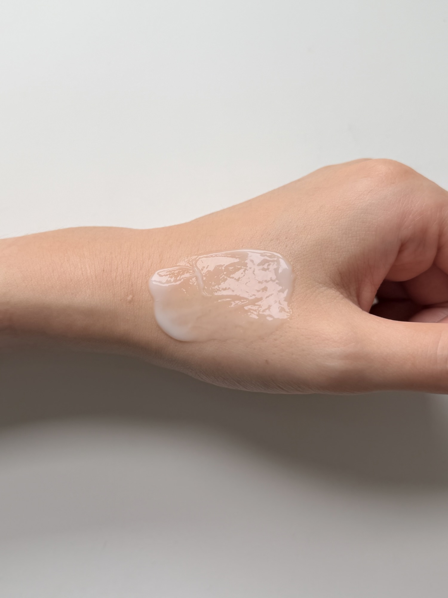 Torriden Balanceful Cica Cream being spread across the back of a hand showing the easy, non-tacky glide