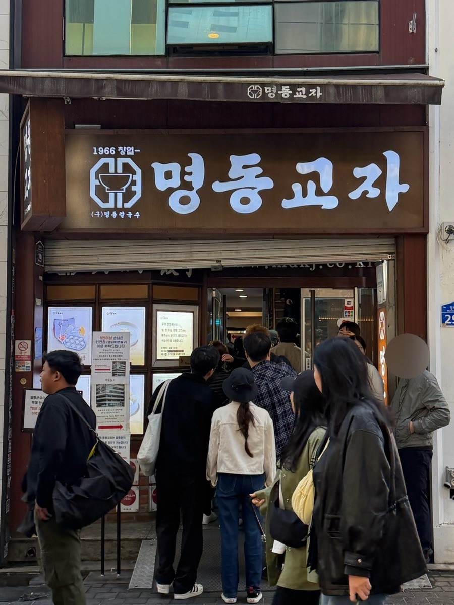 Crowd queueing at the entrance of Myeongdong Kyoja main branch in Myeongdong, Seoul