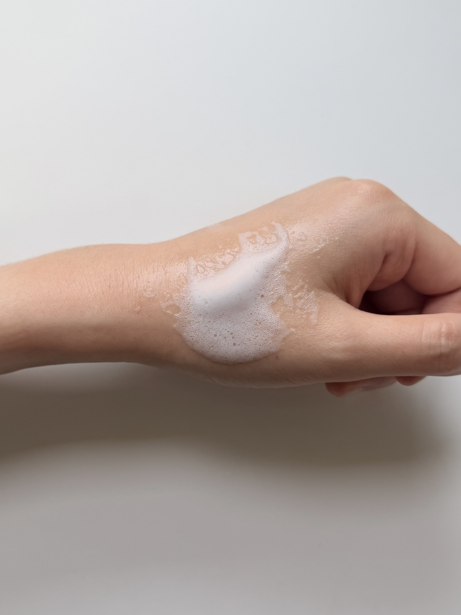 MENOKIN Lift Bubble Mask being spread across the back of a hand