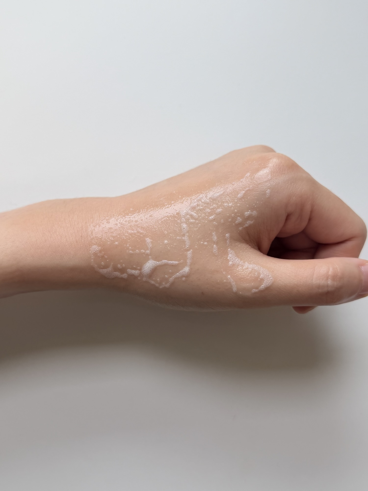 MENOKIN Lift Bubble Mask partially absorbed on the back of a hand