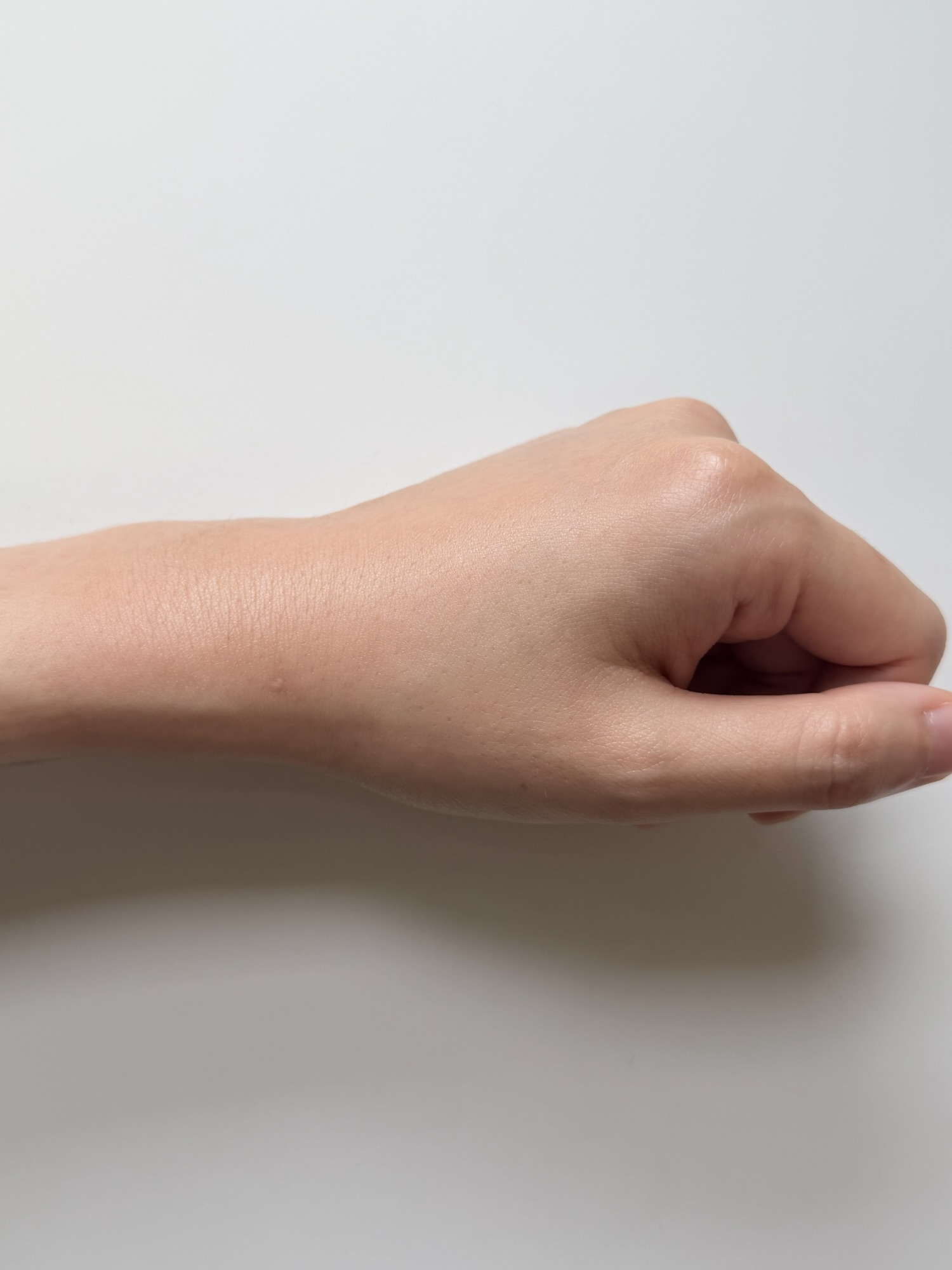 Back of hand after MENOKIN Lift Bubble Mask has absorbed with a subtle hydrated finish