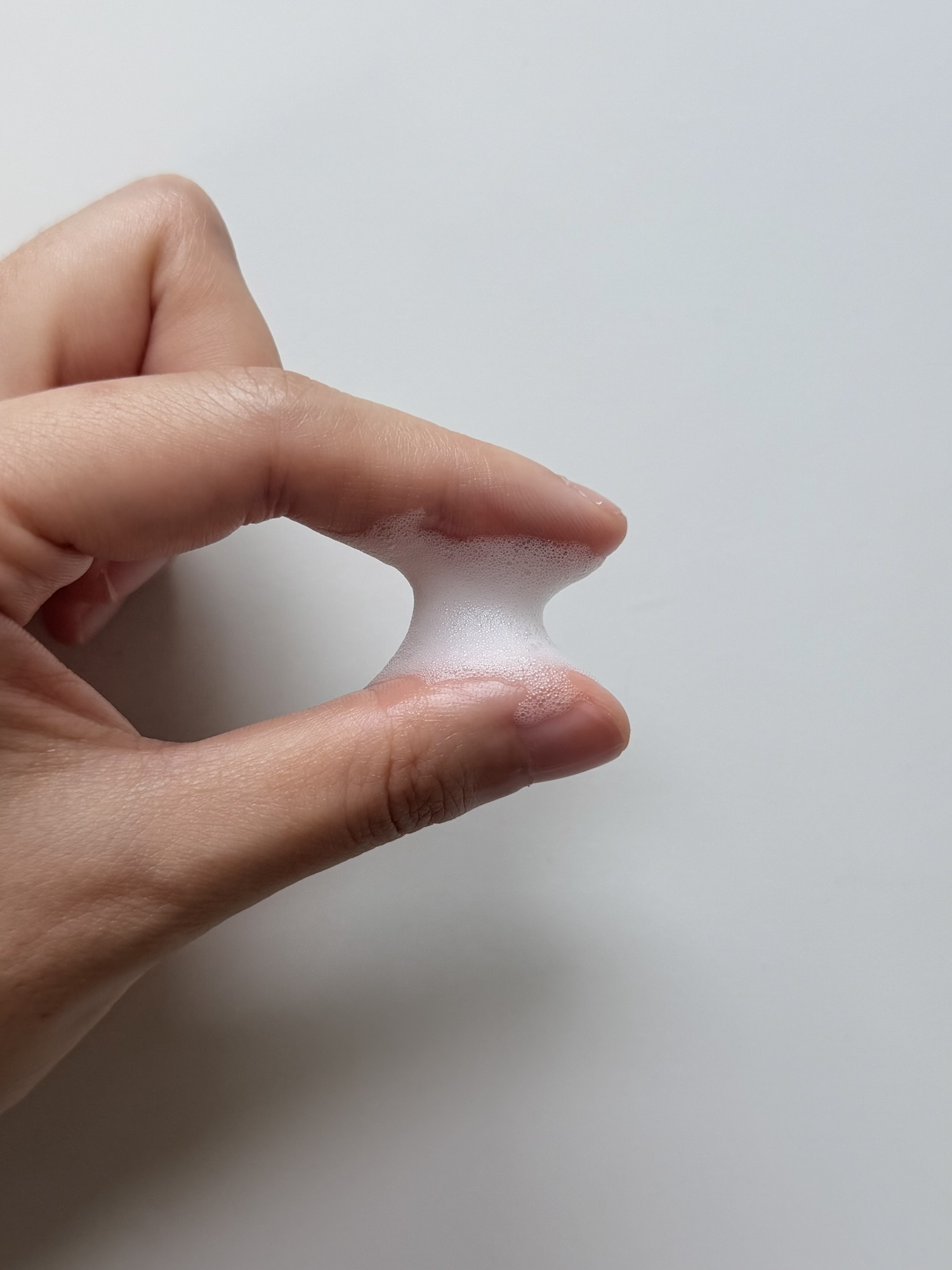 Close-up of dense MENOKIN Lift Bubble Mask foam texture on skin