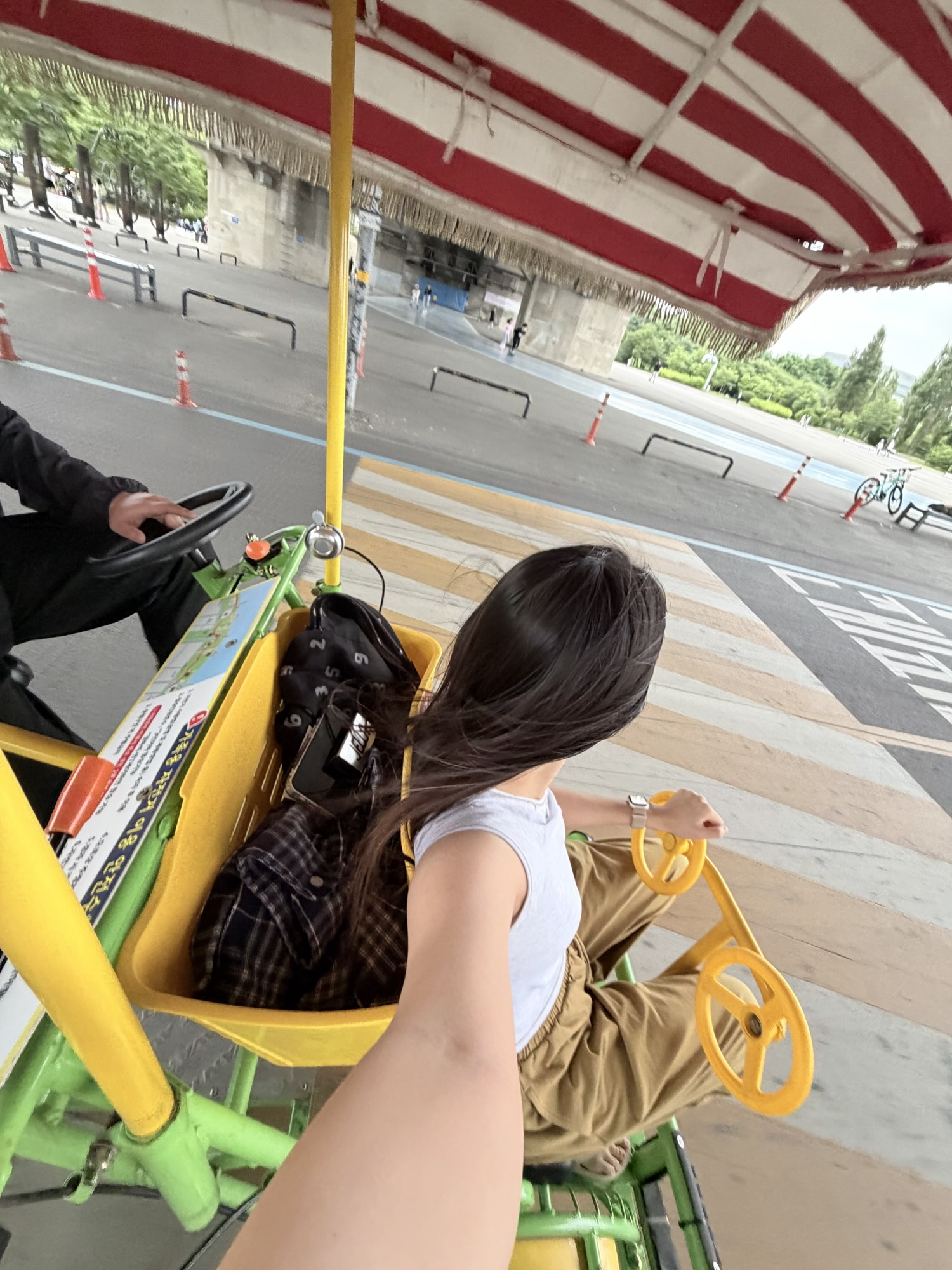 View from the front seat of a family bike riding through Yeouido Hangang Park at sunset