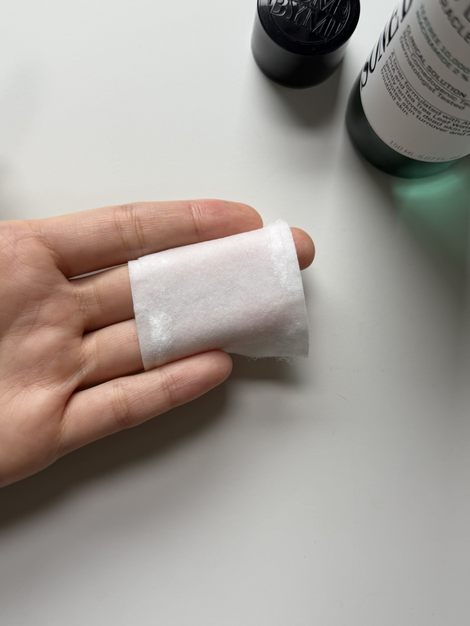 Cotton pad soaked with SOME BY MI Miracle Toner for wipe toner use