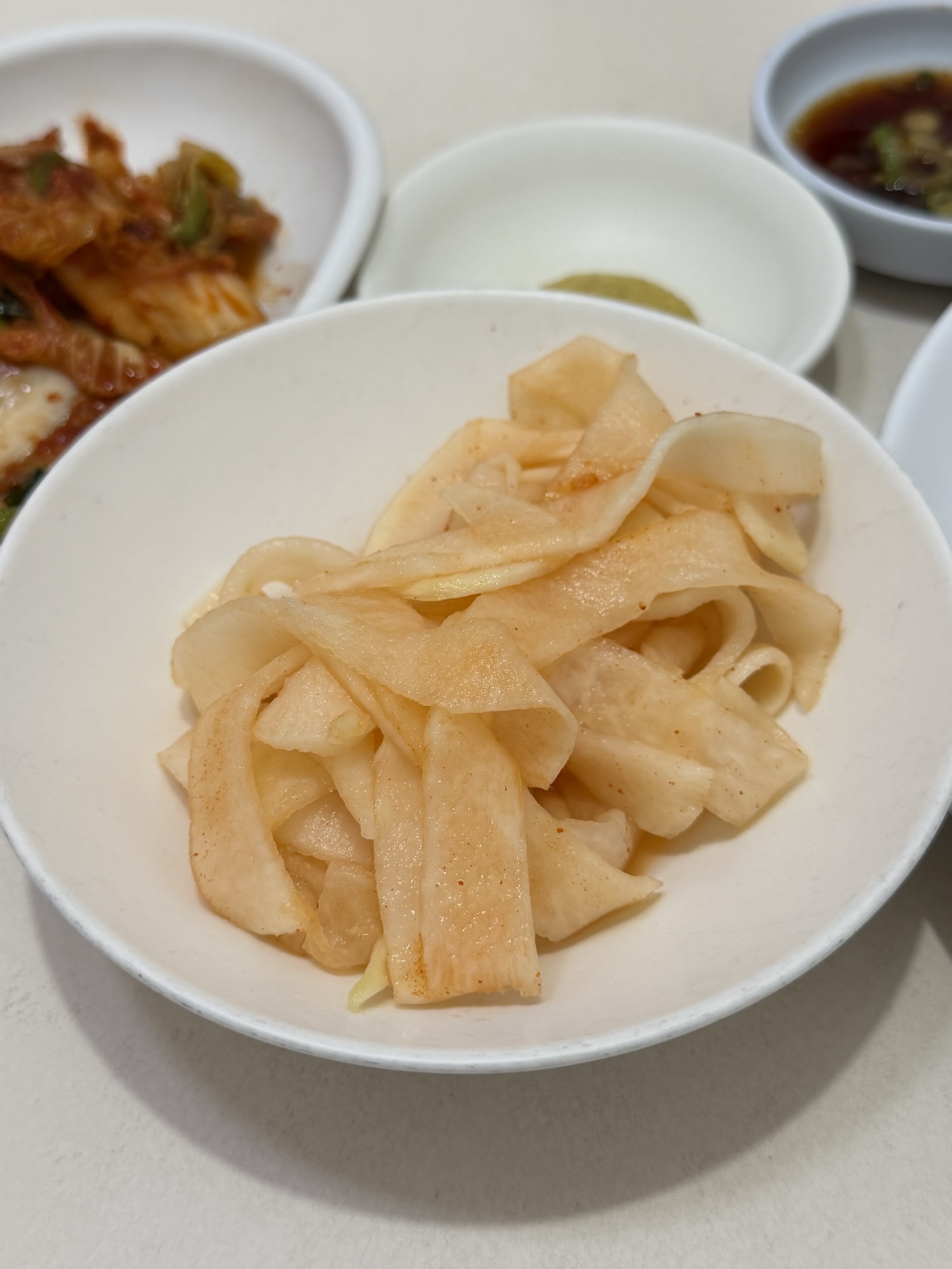 Radish muchim side dish served with Pyongyang naengmyeon at Eulmildae