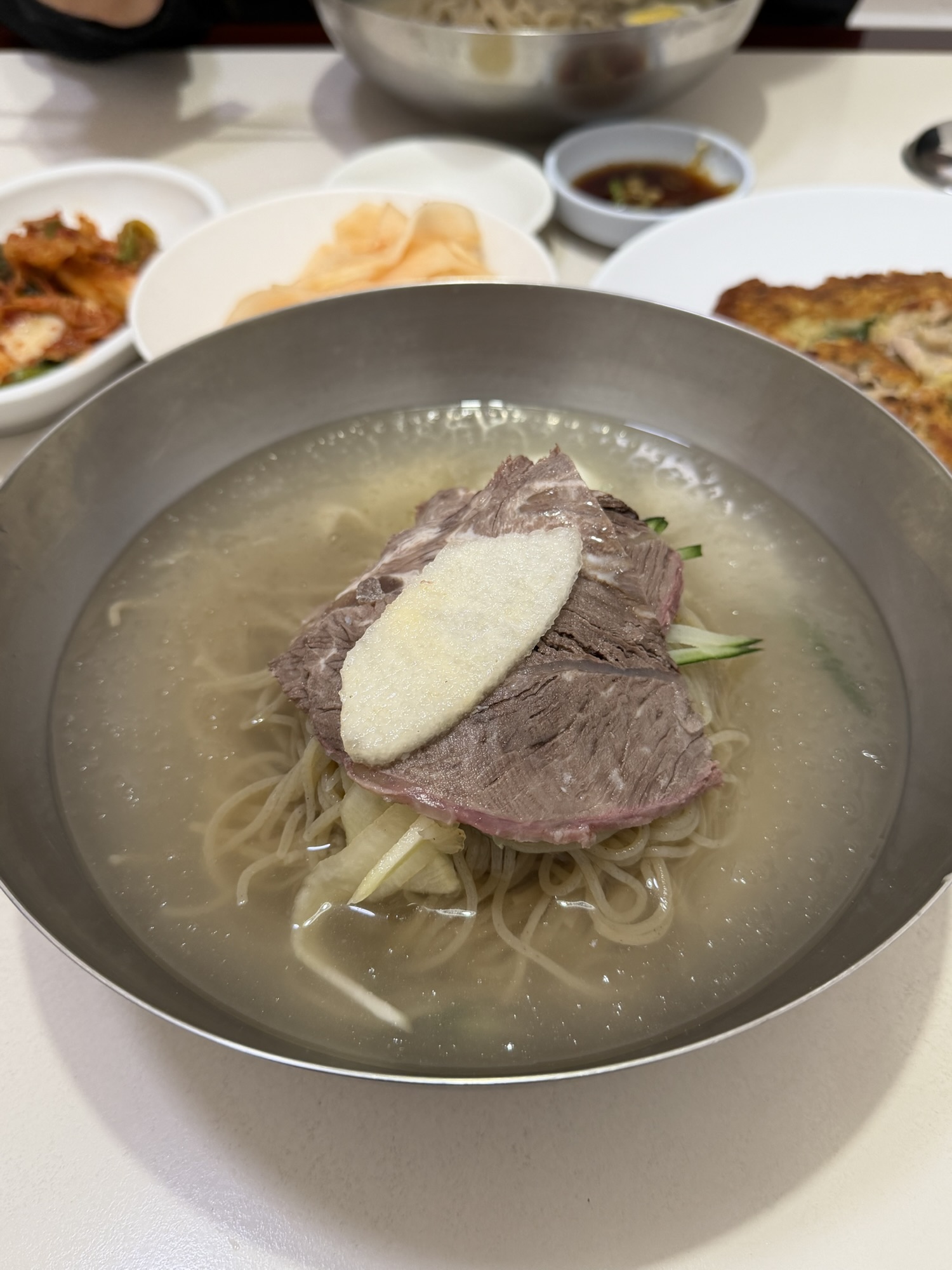 Close-up of Eulmildae mul-naengmyeon with beef, Korean pear, cucumber, radish, and egg