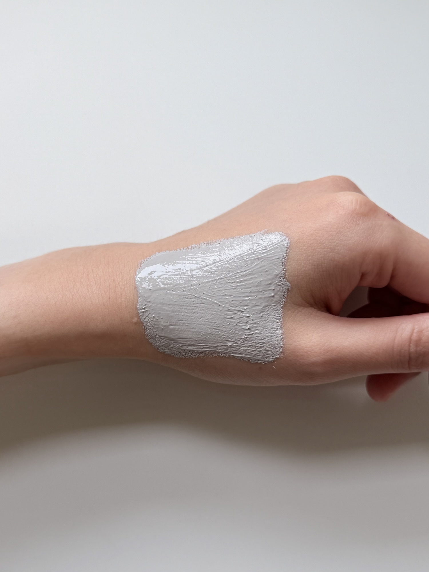 Innisfree Super Volcanic Pore Clay Mask spread across the back of a hand