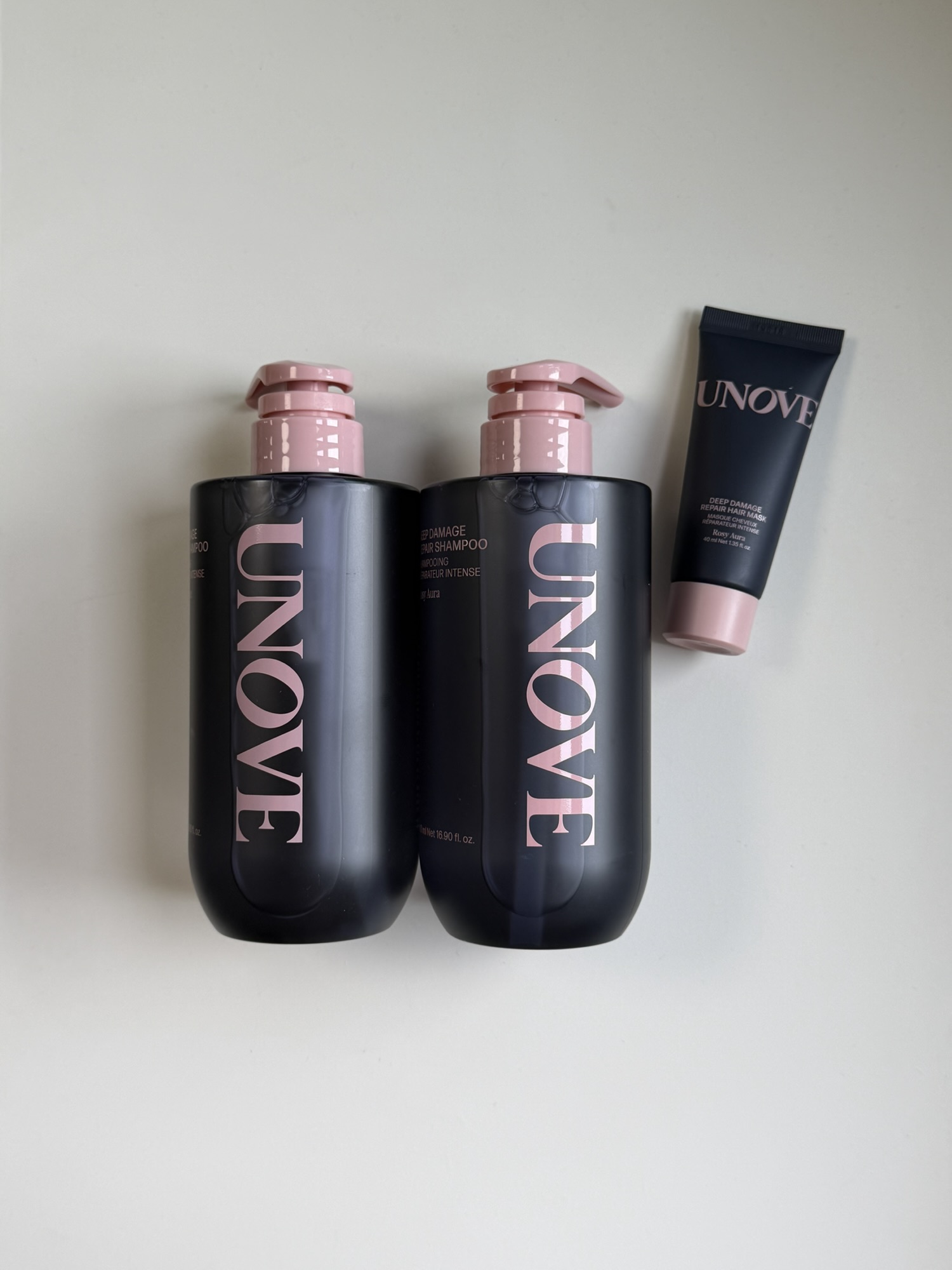 Close-up of UNOVE Deep Damage Repair Shampoo pump bottle