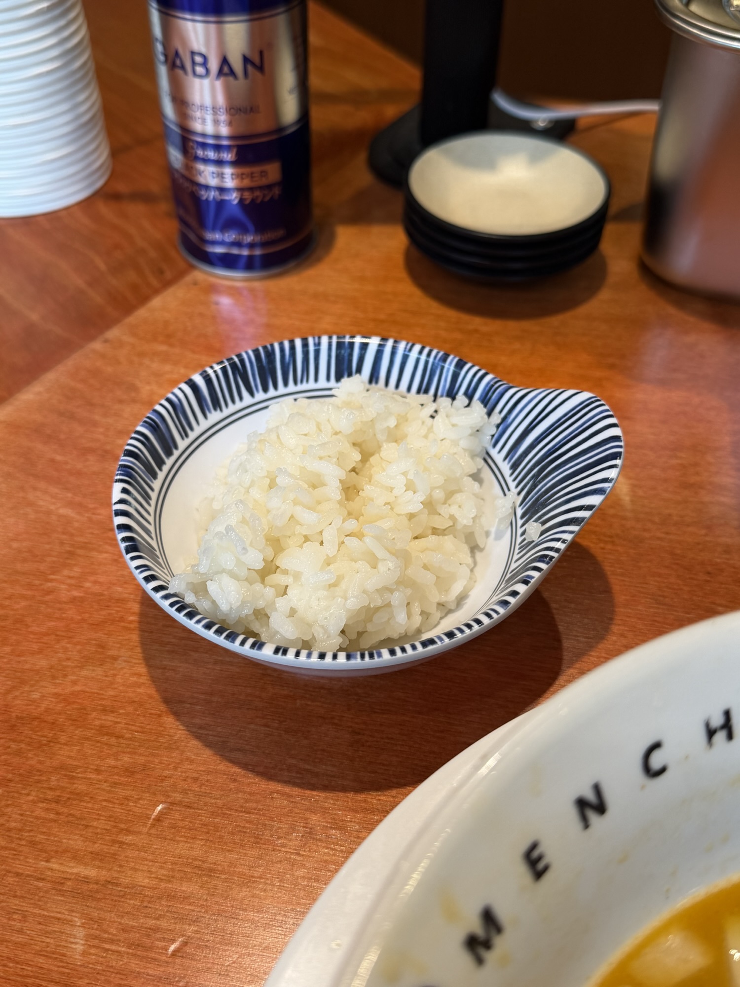 Free rice added at the end of a spicy paitan ramen meal at Menchuru Yeouido