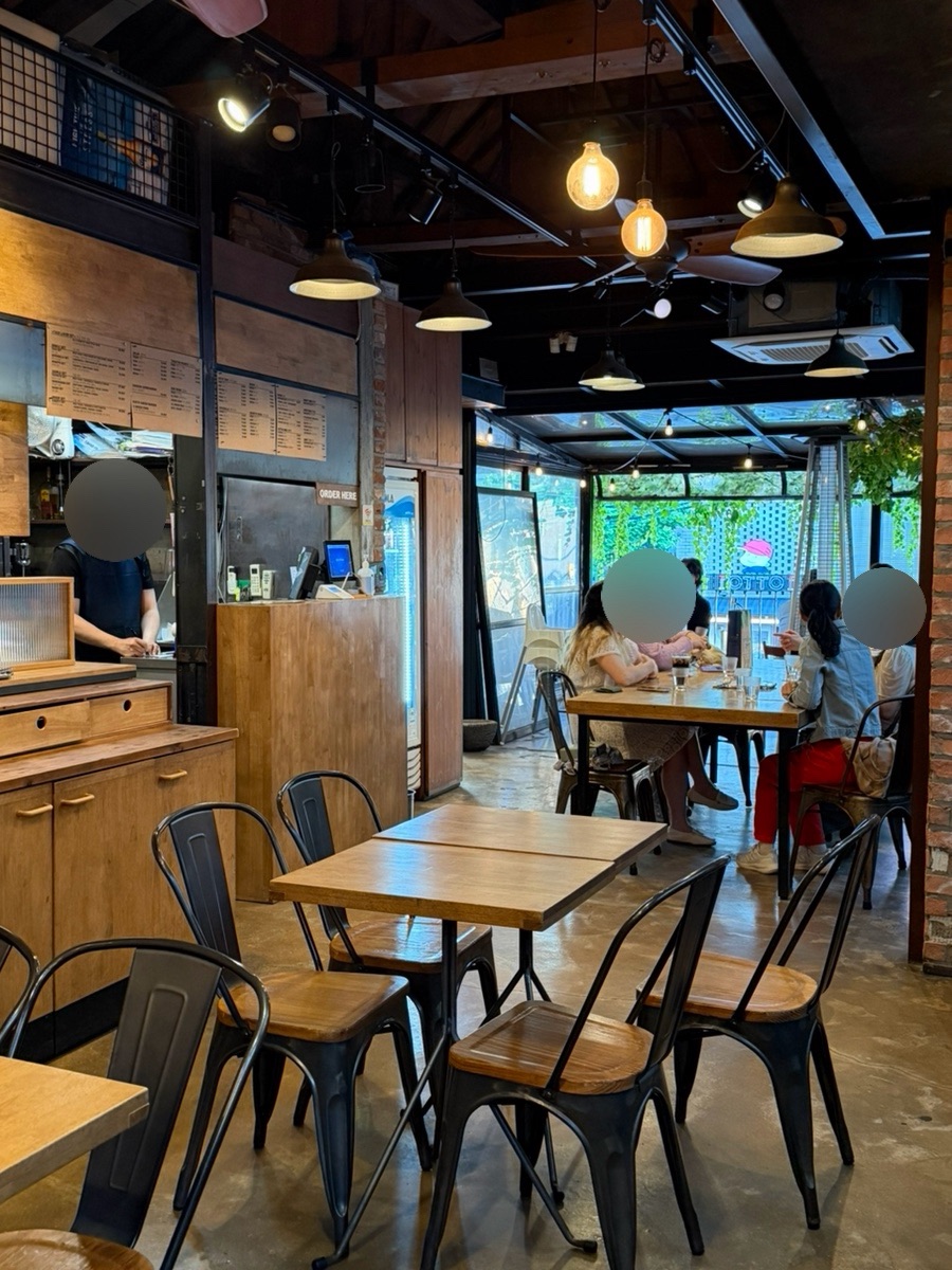 Relaxed Gusto Taco interior with tables and terrace seating near the window