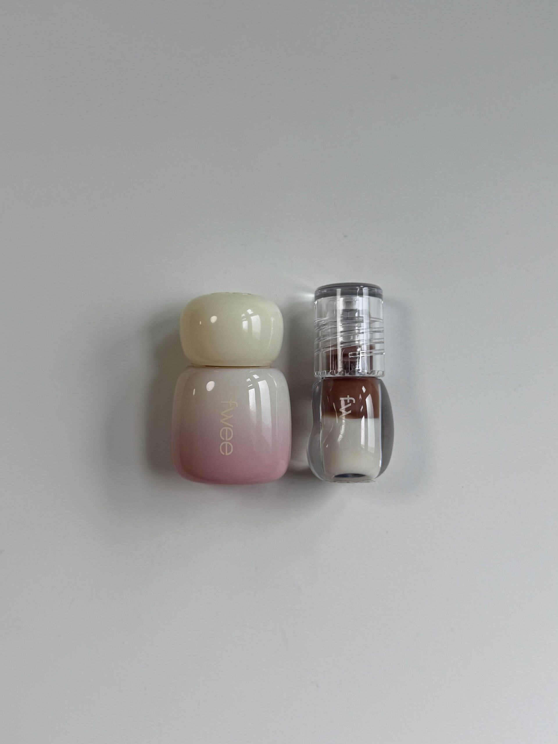 fwee Vanilla lip product and Latte gloss set on a white surface