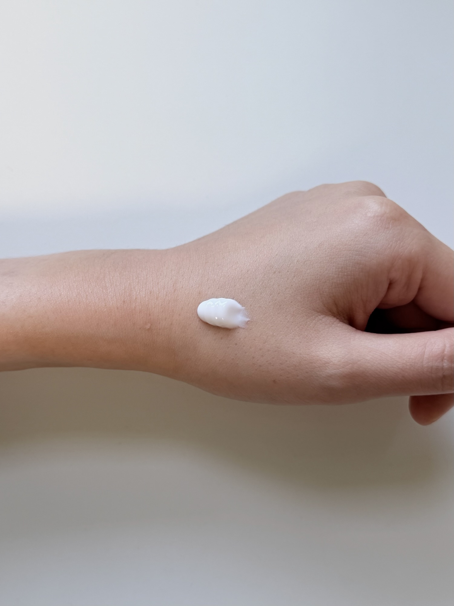Small amount of Kopher Curepair Mela Cream on the back of a hand