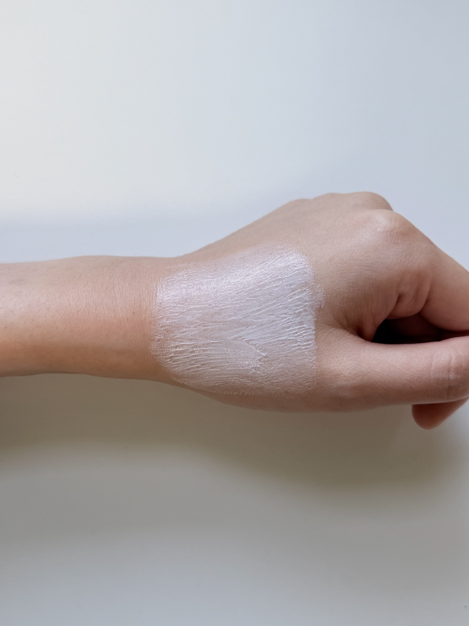 Kopher Curepair Mela Cream spread on the back of a hand before absorbing