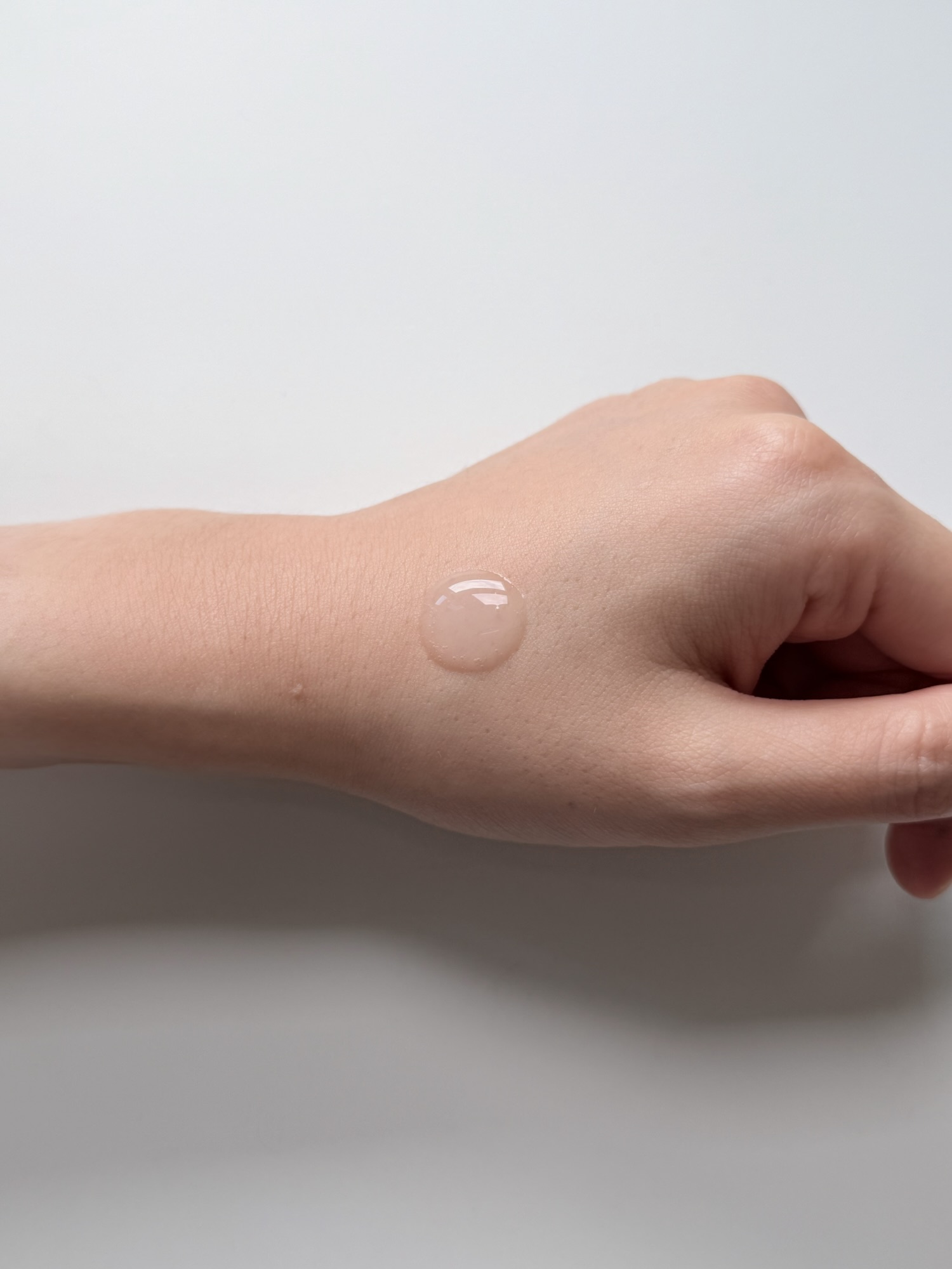 One drop of Mediheal Madecassoside serum on the back of a hand