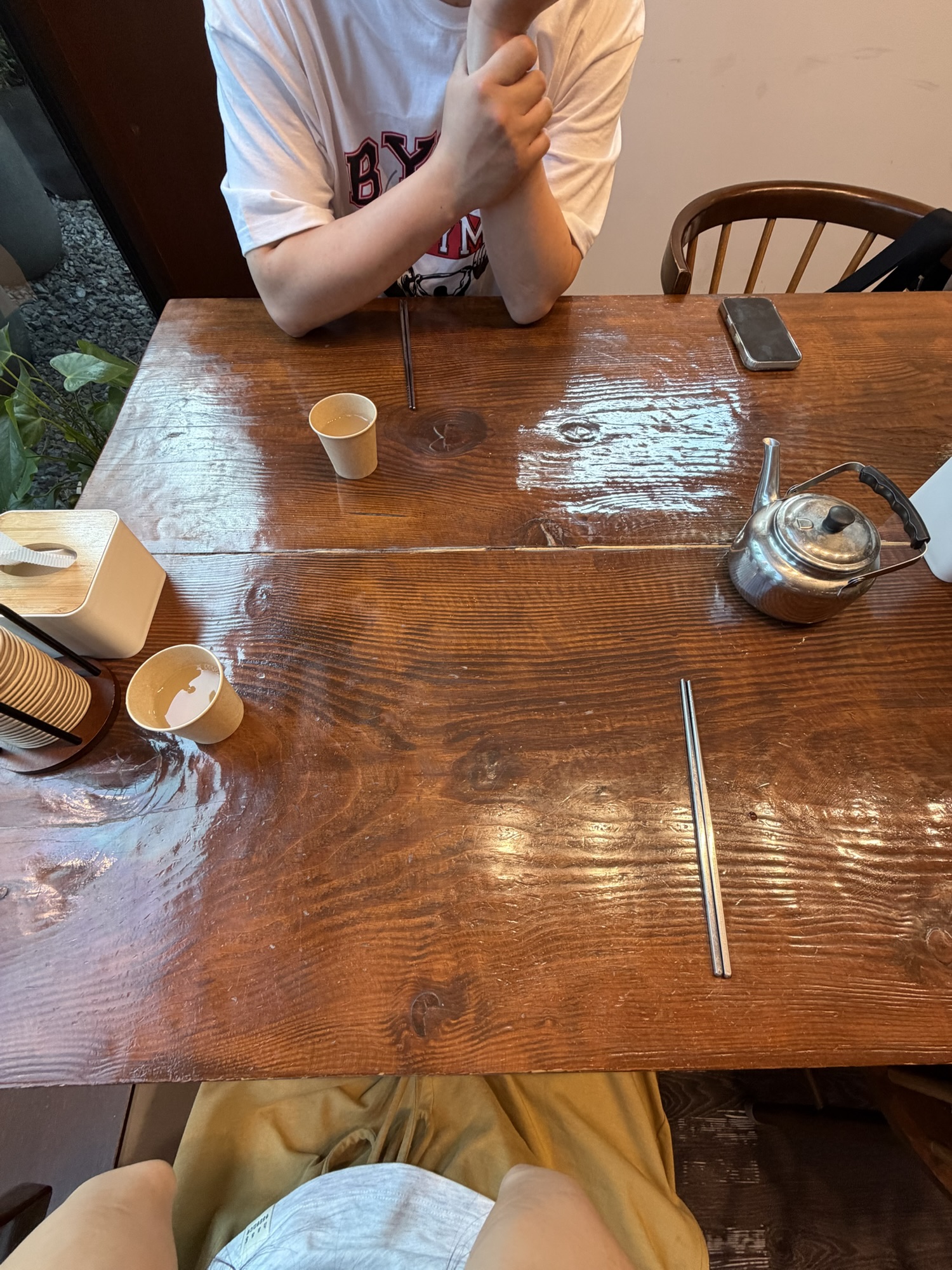 Wooden table inside Gogiri Makguksu with hot buckwheat water