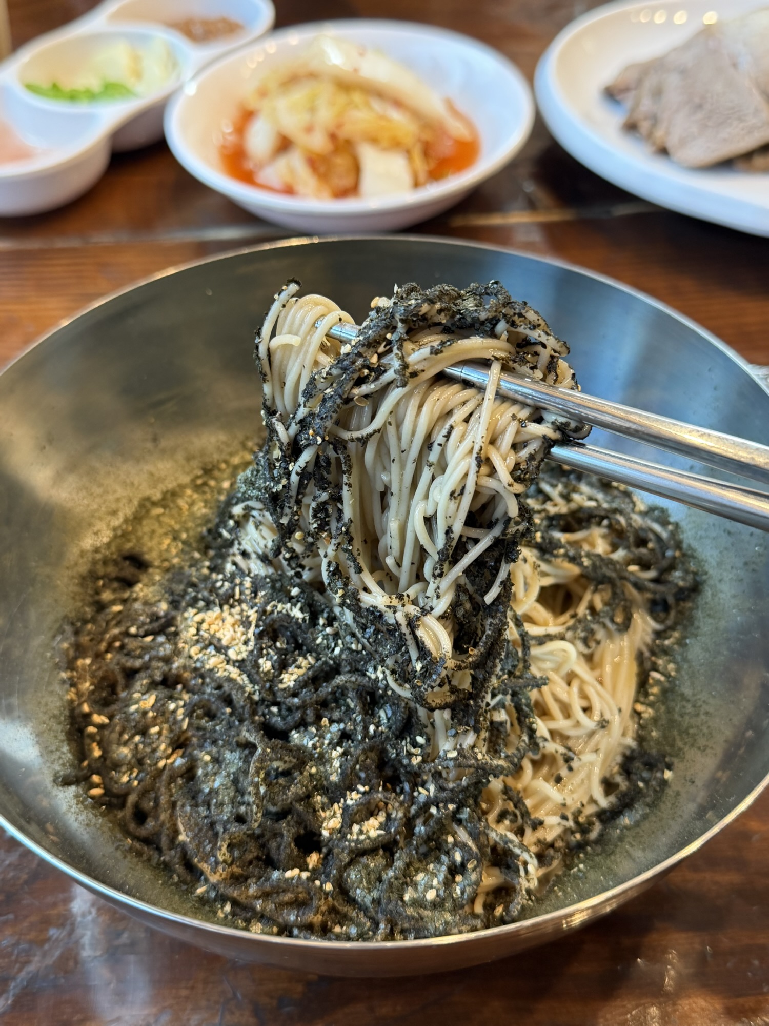 Perilla oil makguksu noodles lifted with roasted seaweed and sesame