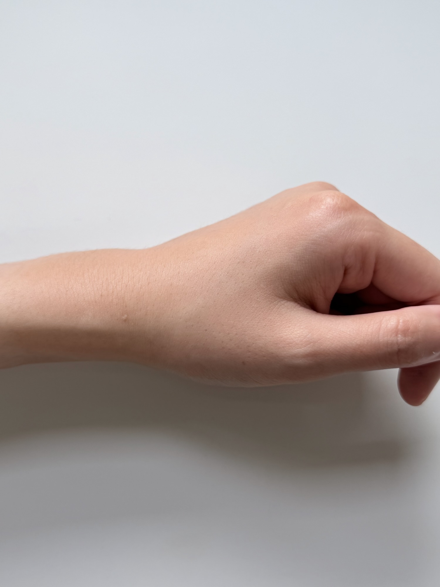Back of a hand after ILLIYOON Ceramide Ato Sun Lotion has absorbed with no white cast