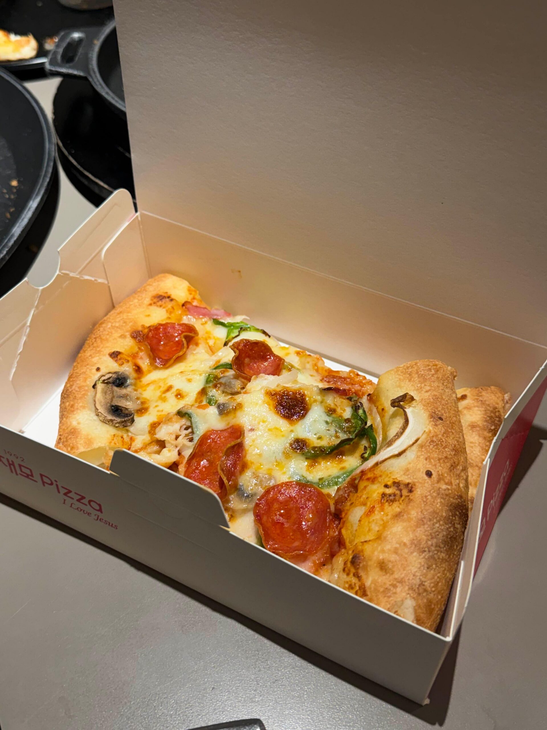 Leftover Lee Jaemo Pizza packed in a takeout box