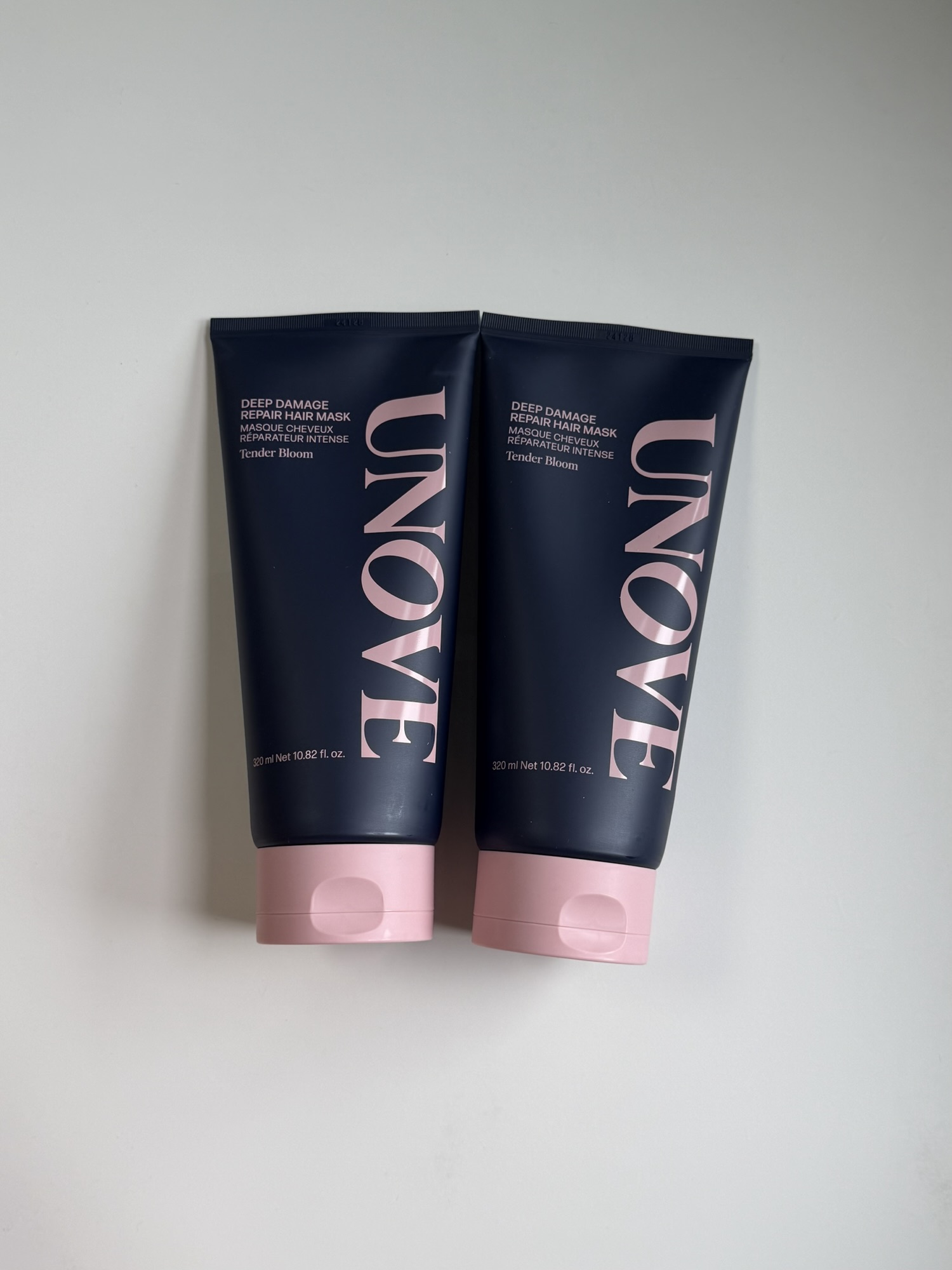 UNOVE Deep Damage Repair Hair Mask tube placed on a white surface