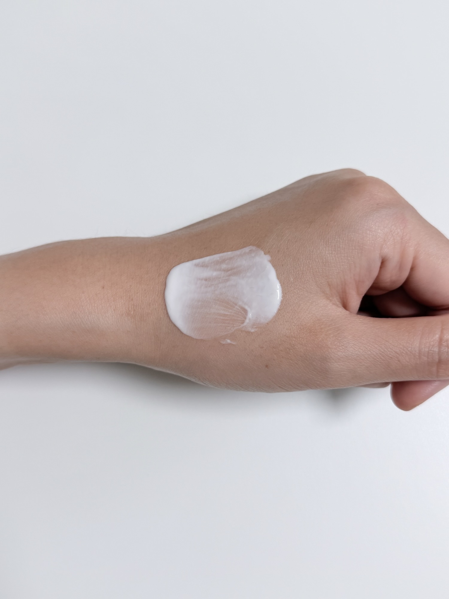 VT PDRN Air Cloud Sunscreen texture spread across the back of a hand