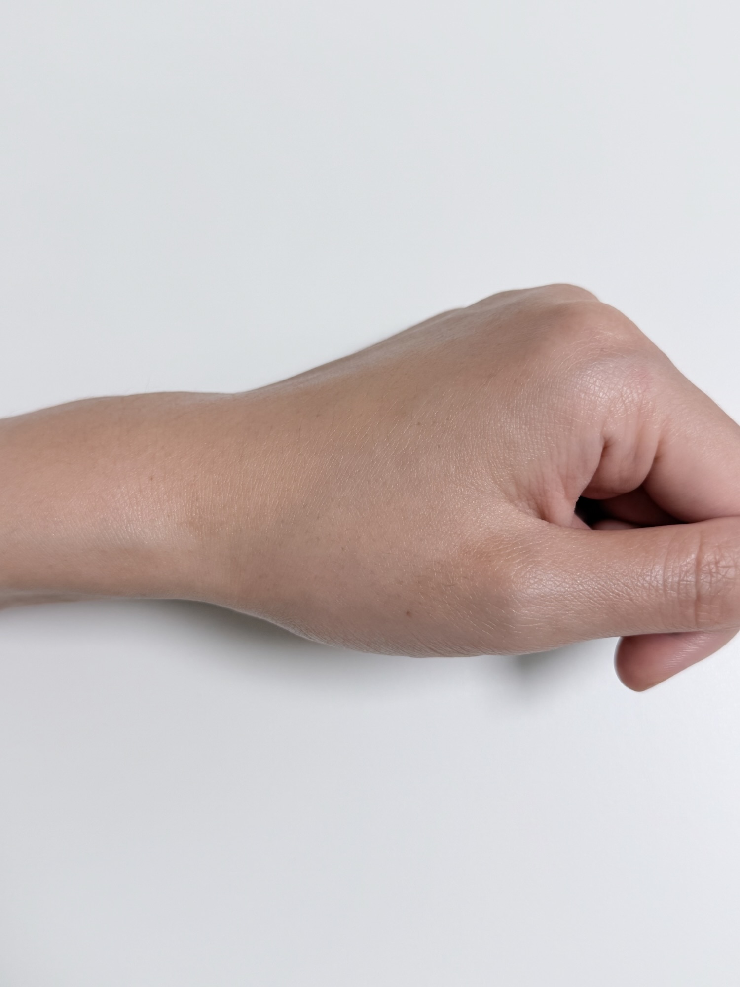 Back of hand after VT PDRN Air Cloud Sunscreen has absorbed with a natural finish