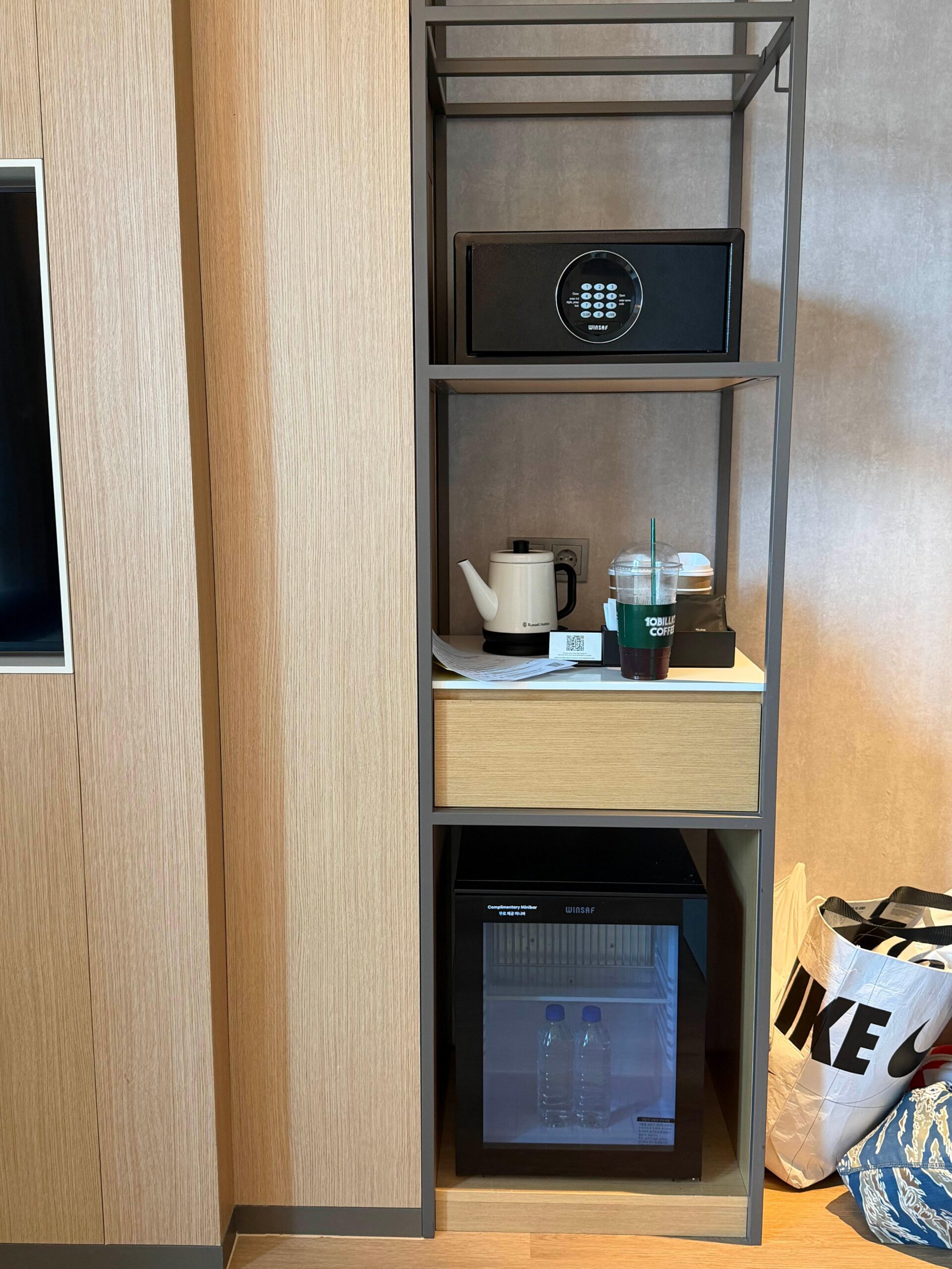Mini fridge and kettle area near the room entrance