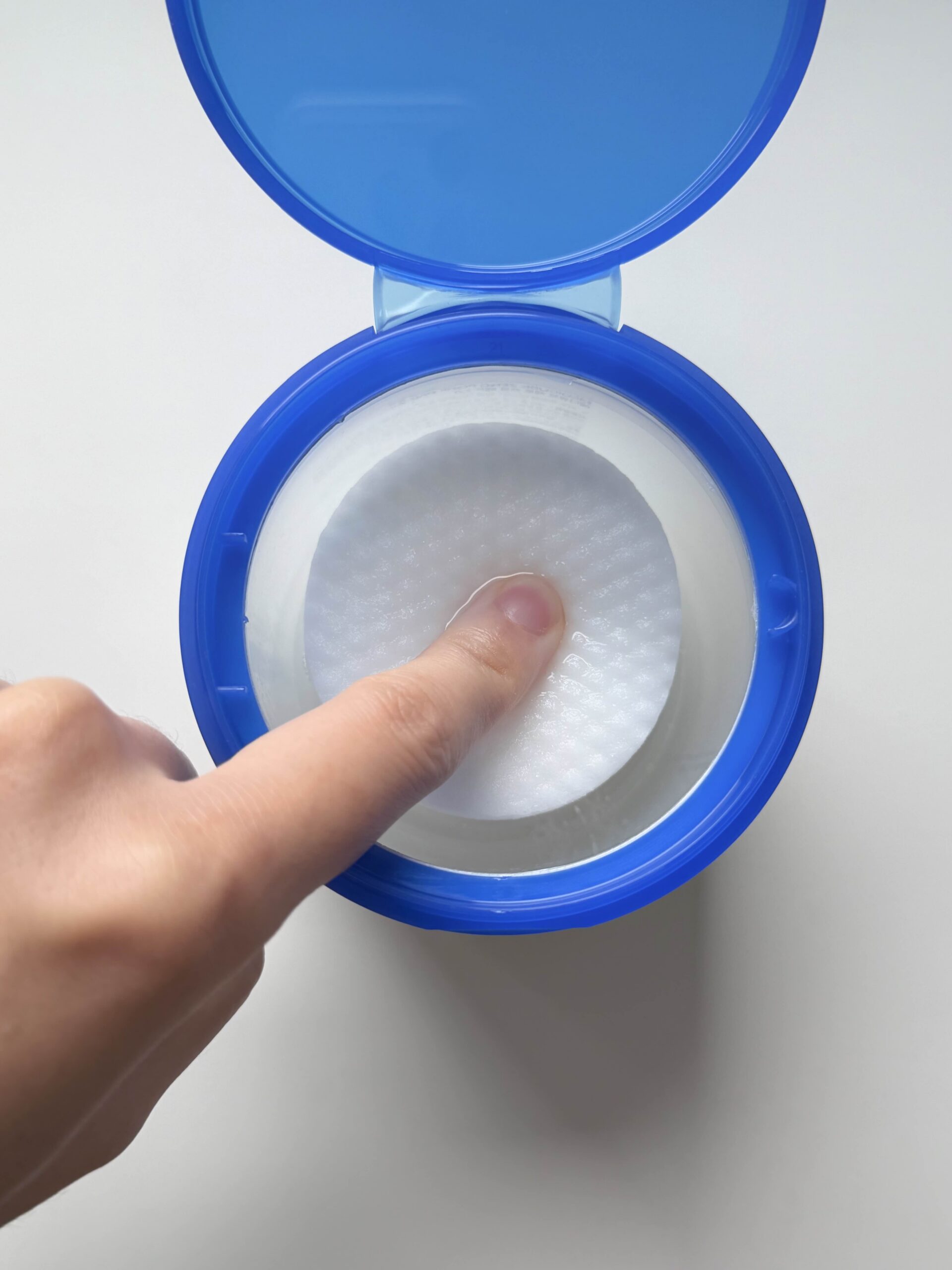 Pressing Medicube Zero Pore Pad 2.0 to show the pad soaked with essence