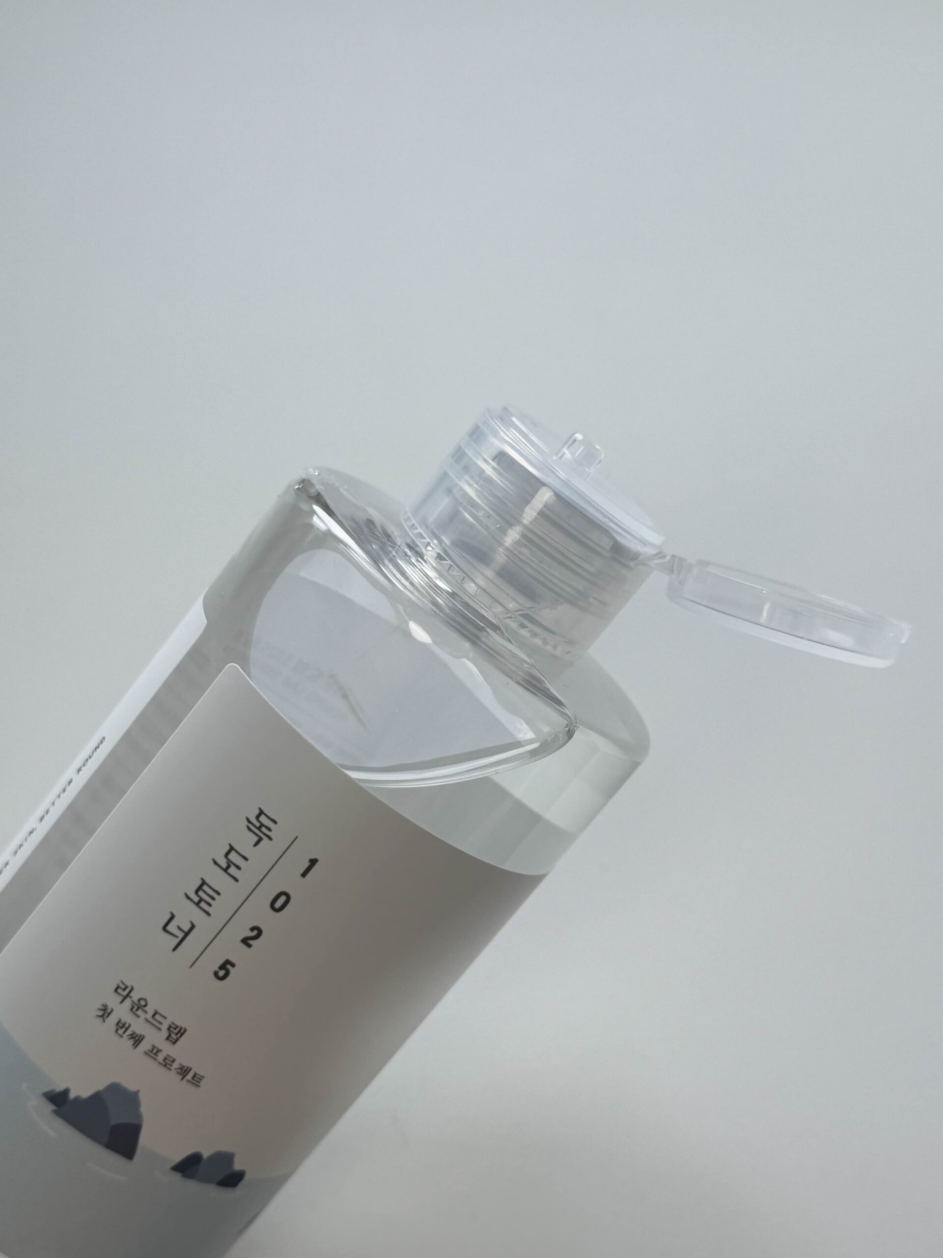 Clear watery texture of Round Lab 1025 Dokdo Toner poured onto the back of a hand
