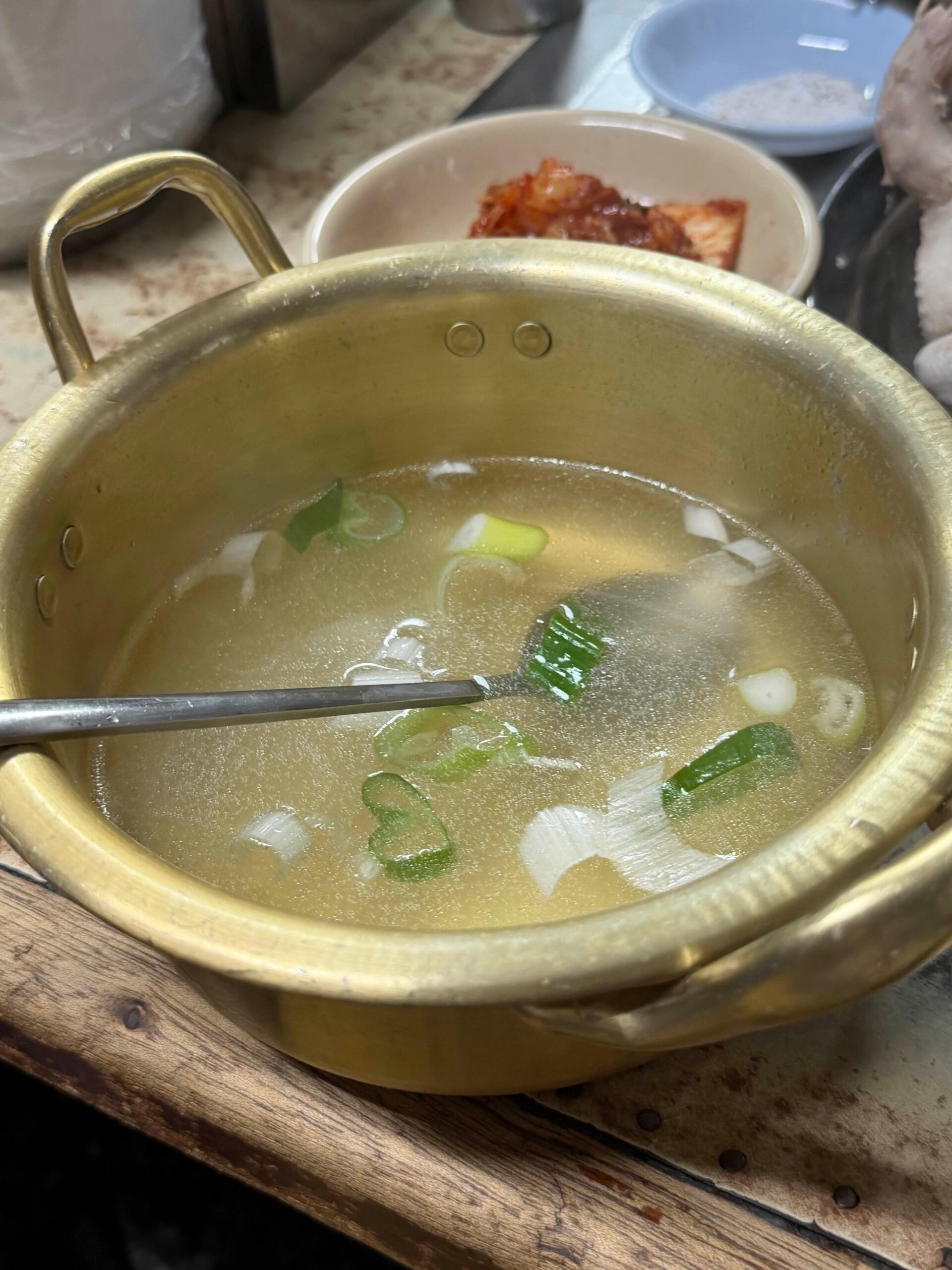 Rich chicken broth served with baeksuk baekban at Sarangbang Kalguksu