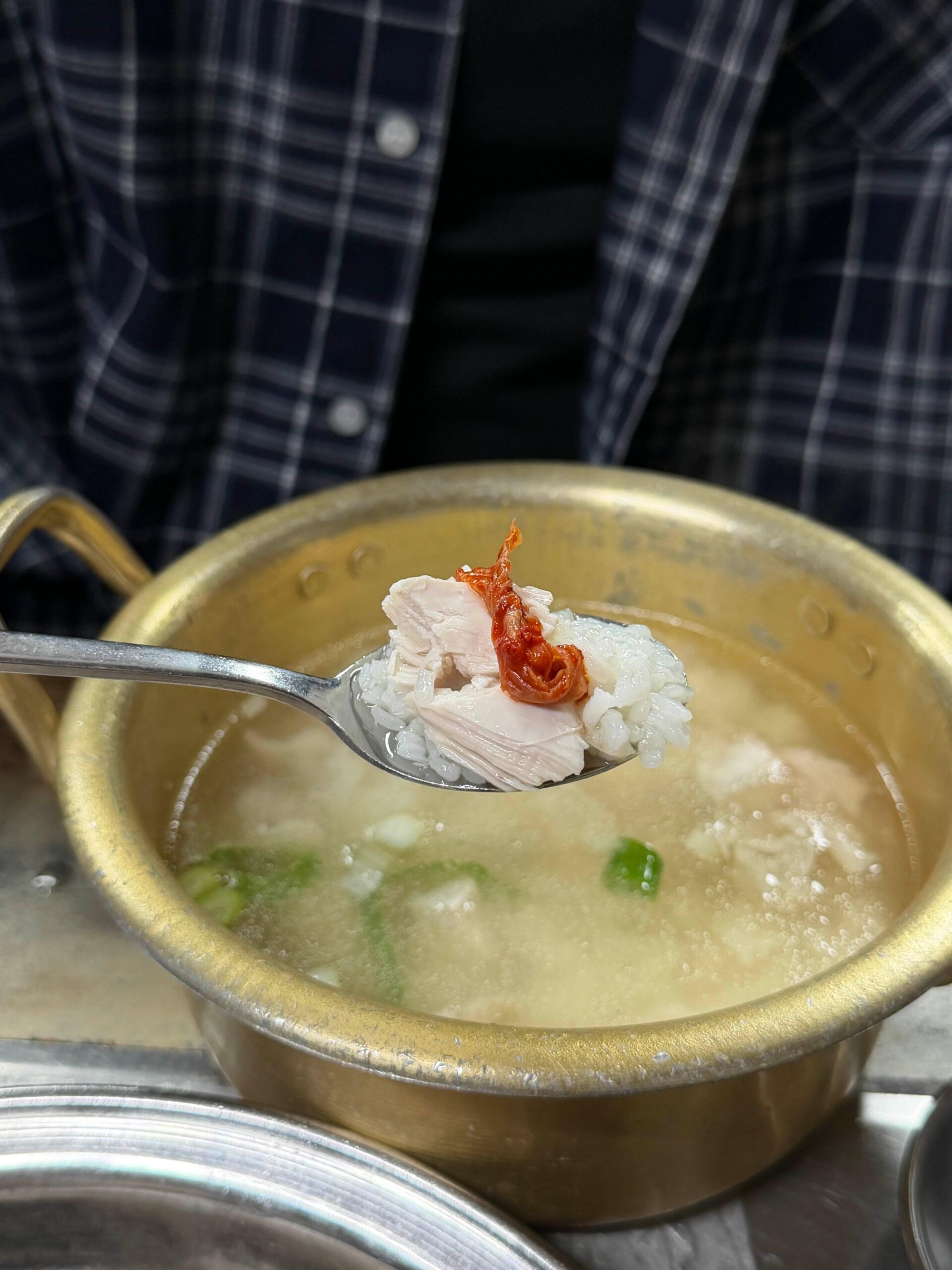 Chicken baeksuk rice bite with kimchi at Sarangbang Kalguksu