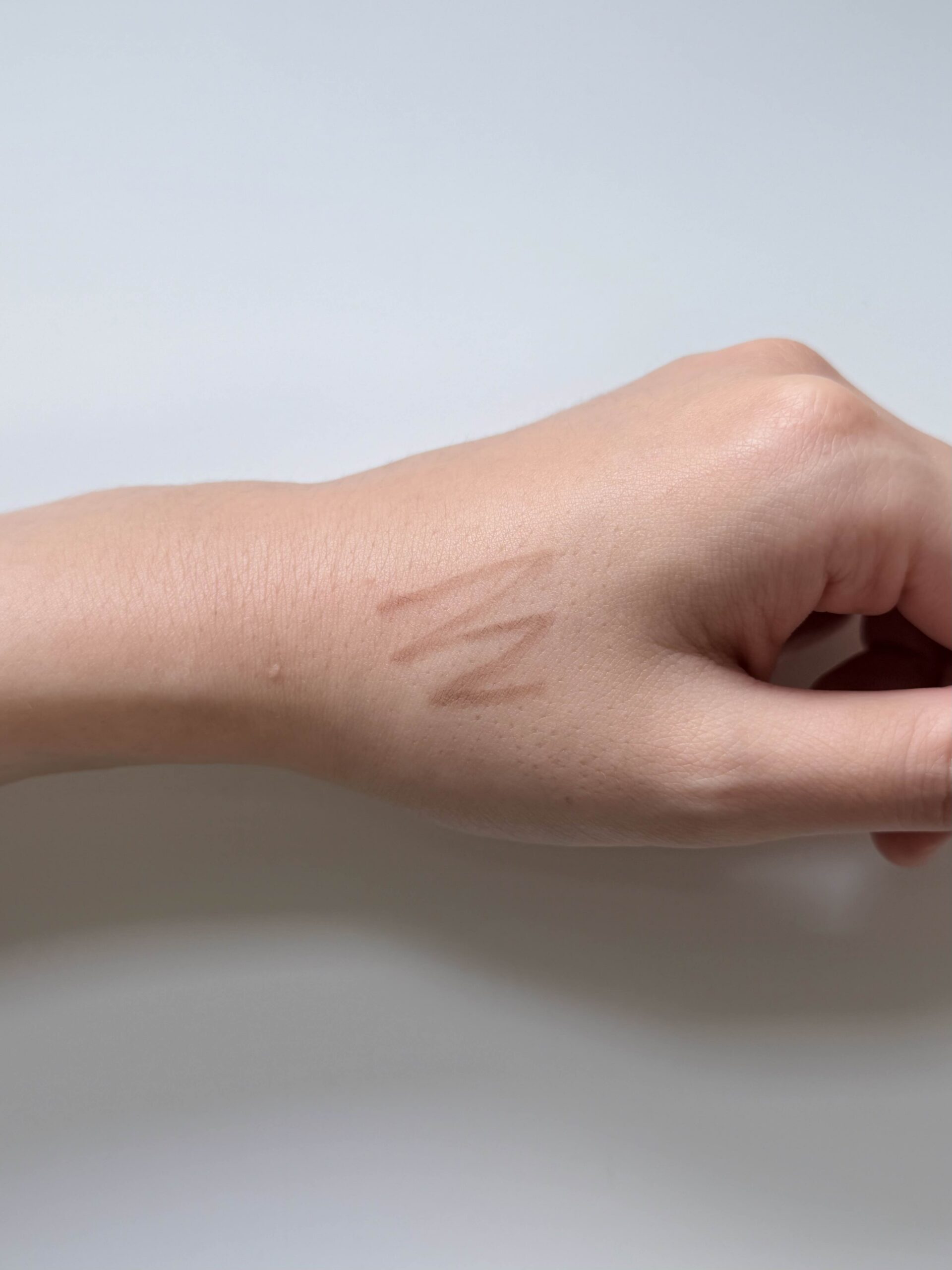 Natural Brown Wakemake brow pencil swatch on the back of a hand