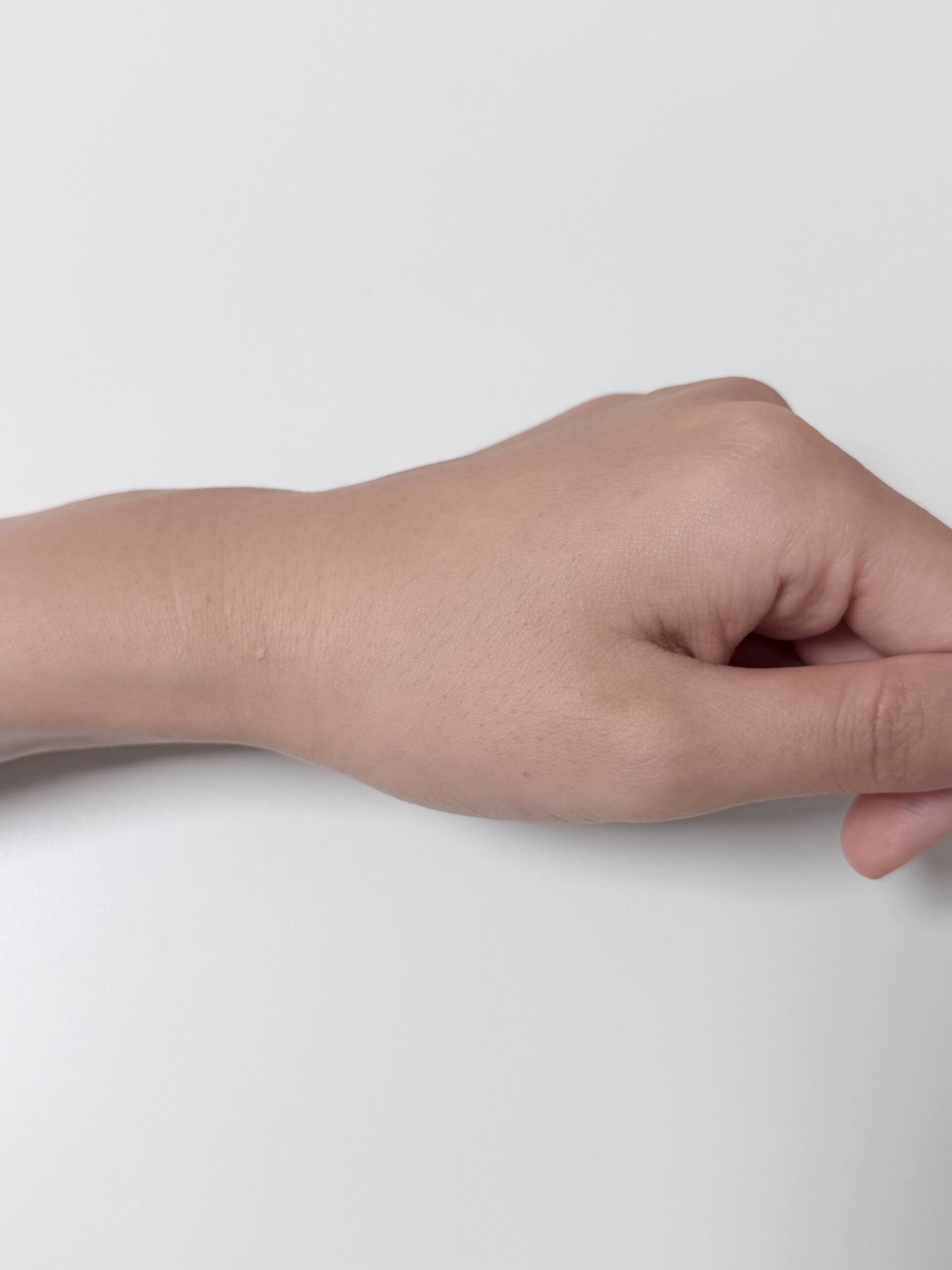 Daiso VT PDRN Glow Toner absorbed finish on the back of a hand